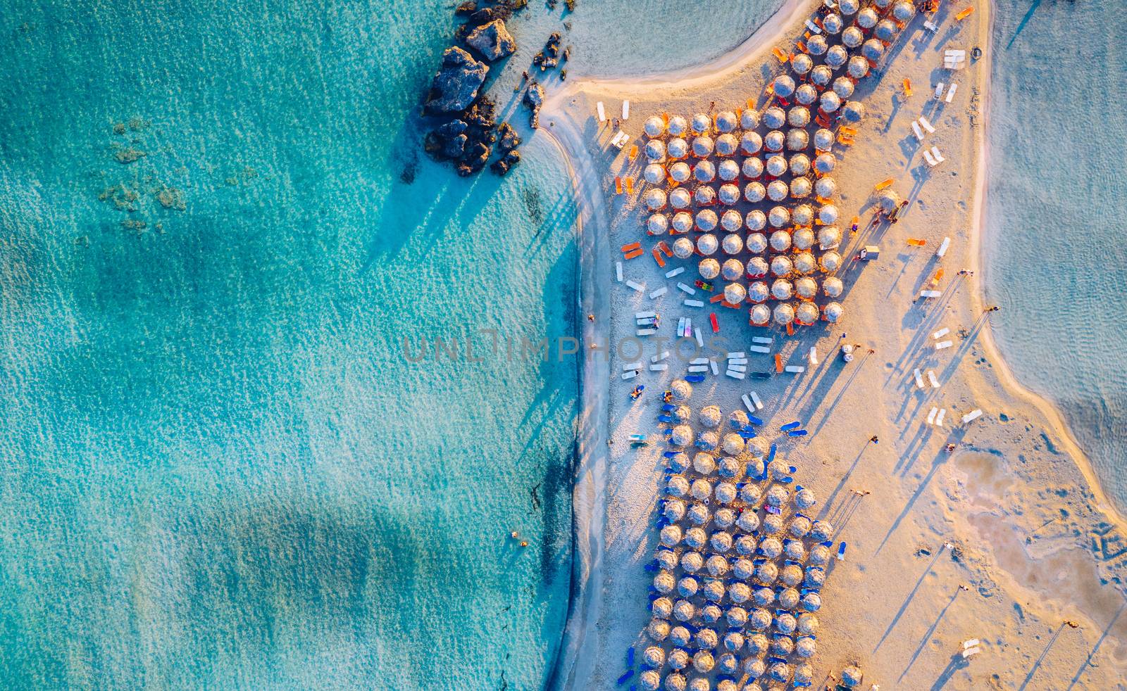 Aerial view of beautiful tropical Elafonissi Beach with pink sand. View of a nice tropical Elafonissi beach from the air. Beautiful sky, sea, resort. Elafonissi beach, Crete, Greece.