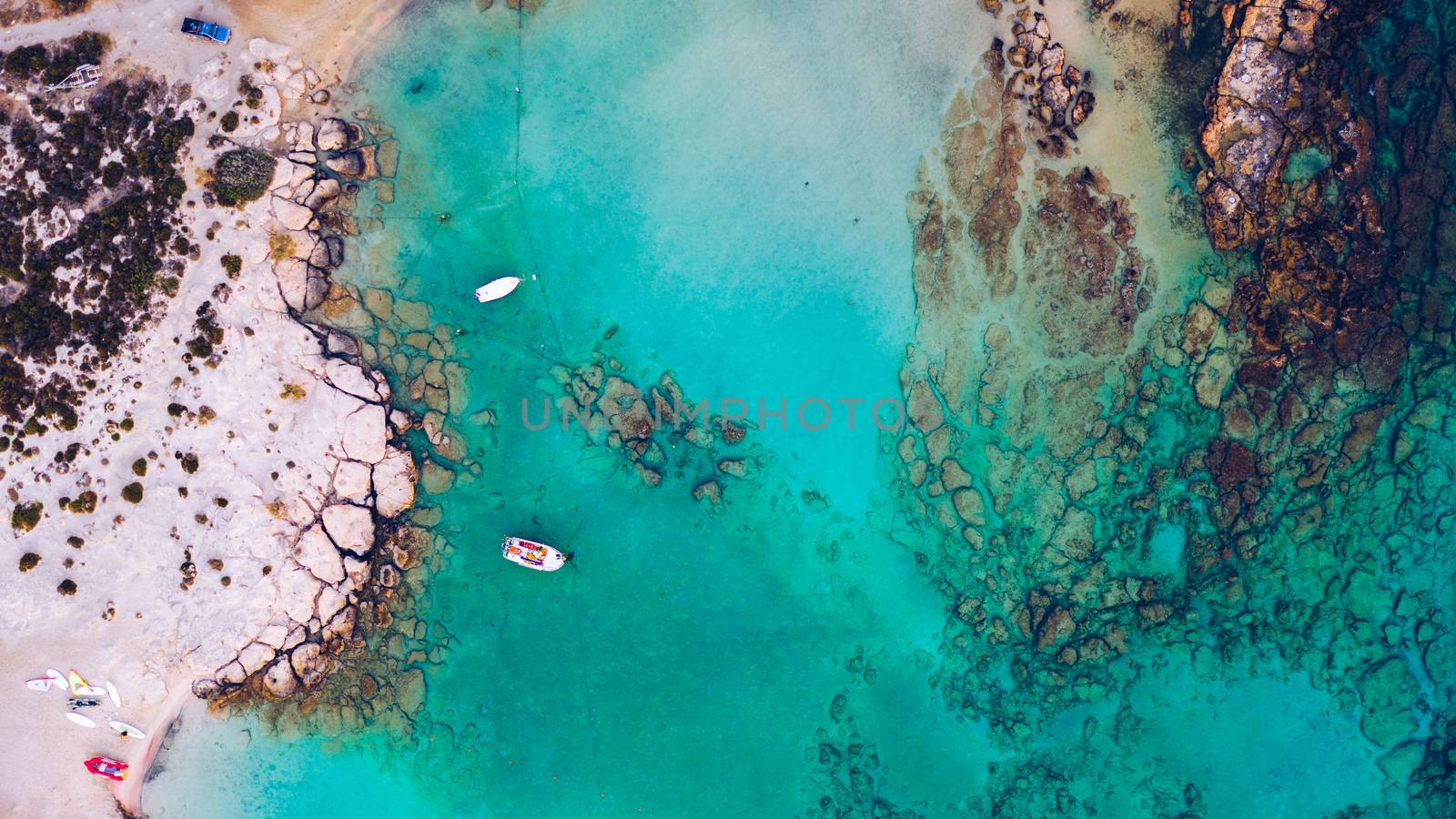 Aerial view of beautiful tropical Elafonissi Beach with pink sand. View of a nice tropical Elafonissi beach from the air. Beautiful sky, sea, resort. Elafonissi beach, Crete, Greece.