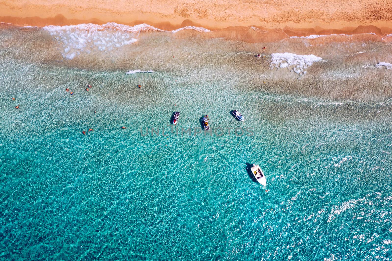 People swimming in the sea. Aerial view, Top view. The color of the water and beautifully bright. Swimming and relaxing in the sea blue lagoon aerial top view. Top view from flying drone.