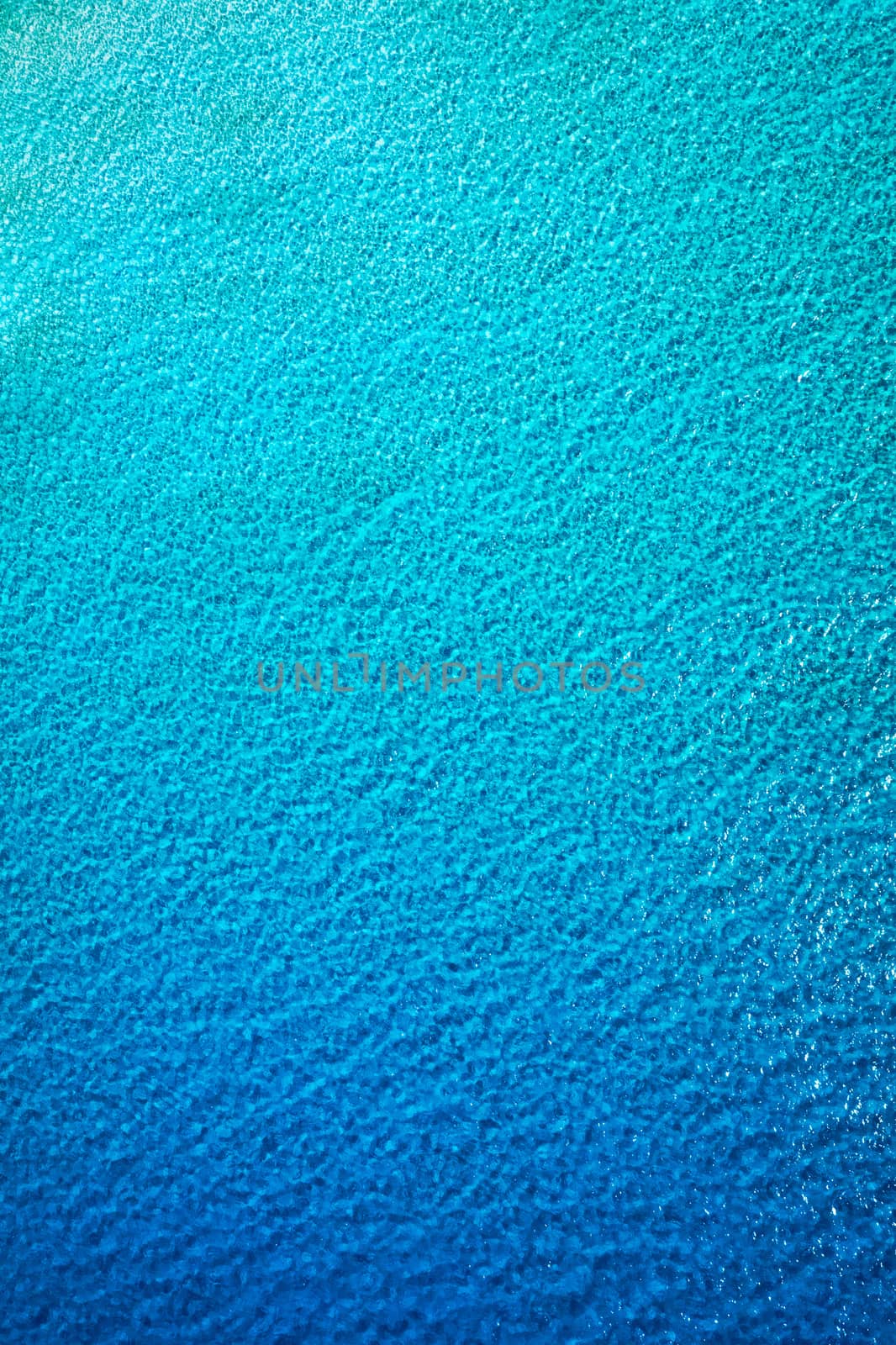 Sea surface aerial view. Background image of the turquoise sea. Deep sea and corals. Aerial drone shot of turquoise water, space for text. Aquamarine background. Sea Aerial view.