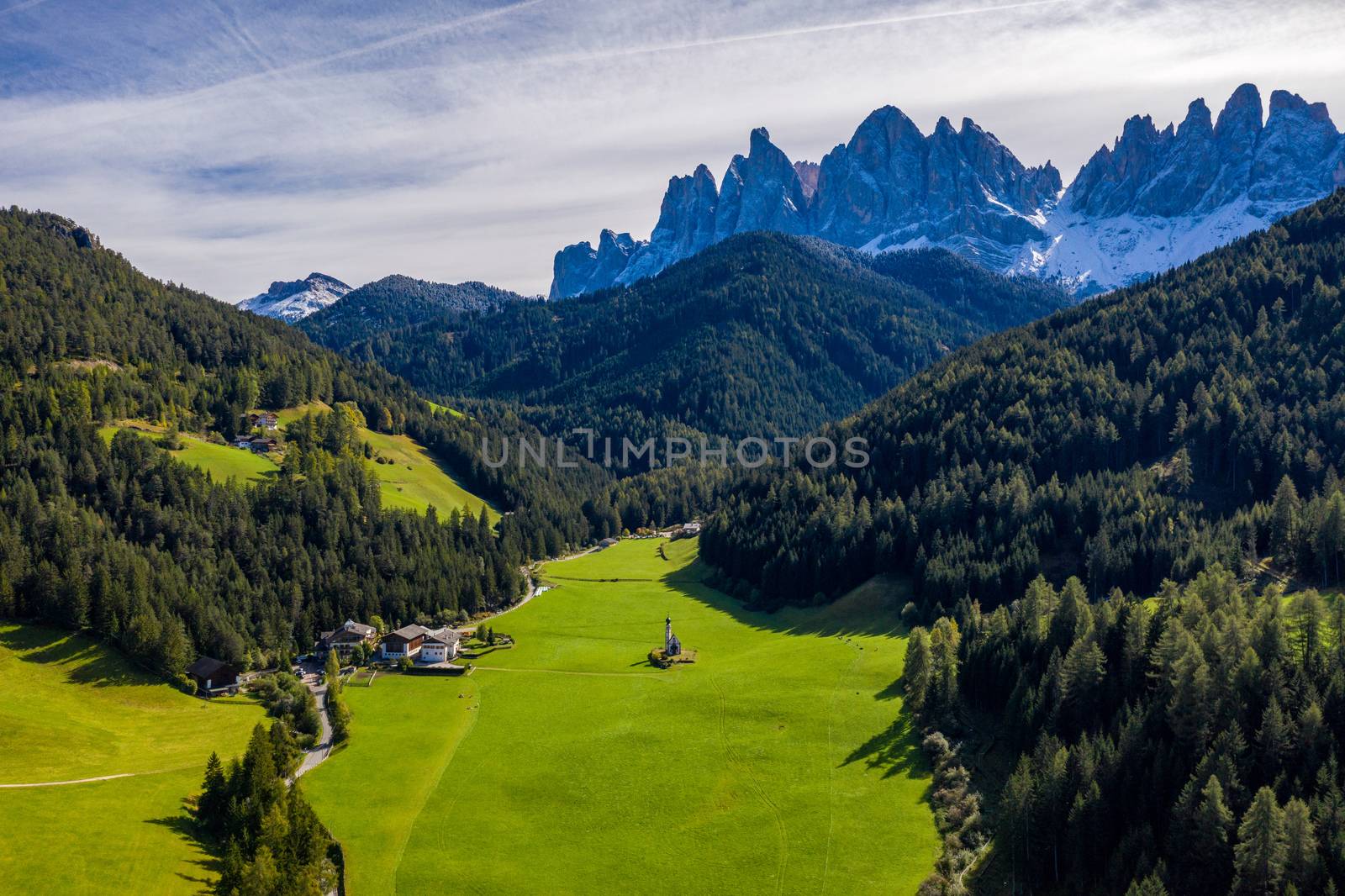 Beautiful landscape with Italian Alps and Church of Saint John located in Ranui, Italy. Val di Funes, Bolzano, Italy. San Giovanni in Ranui church (St John in Ranui church) in the Dolomites, Italy.