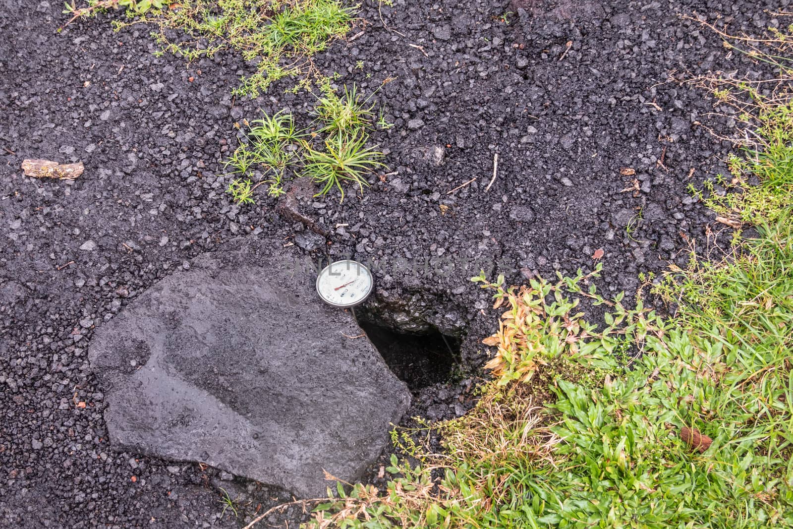 Leilani Estate, Hawaii, USA. - January 14, 2020: Devastation in parts untouched by 2018 lava. Dial placed in crack of road to measure temperature. Placed by government security forces.