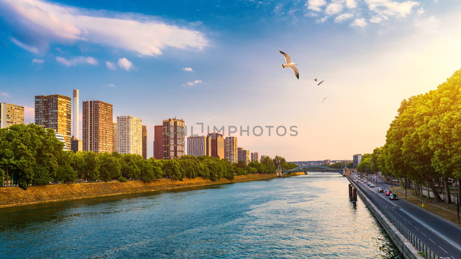 Towers and skyscrapers in Paris, France, used as office buildings as well as office buildings, by the water in front of barges on the river Seine in Quai de Grenelle, Front-de-Seine District. Paris