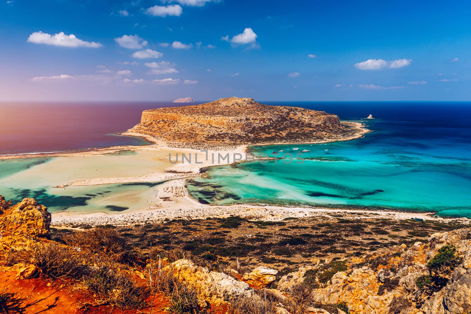 Fantastic panorama of Balos Lagoon and Gramvousa island on Crete, Greece. Cap tigani in the center. Balos beach on Crete island, Greece. Tourists relax and bath in crystal clear water of Balos beach.