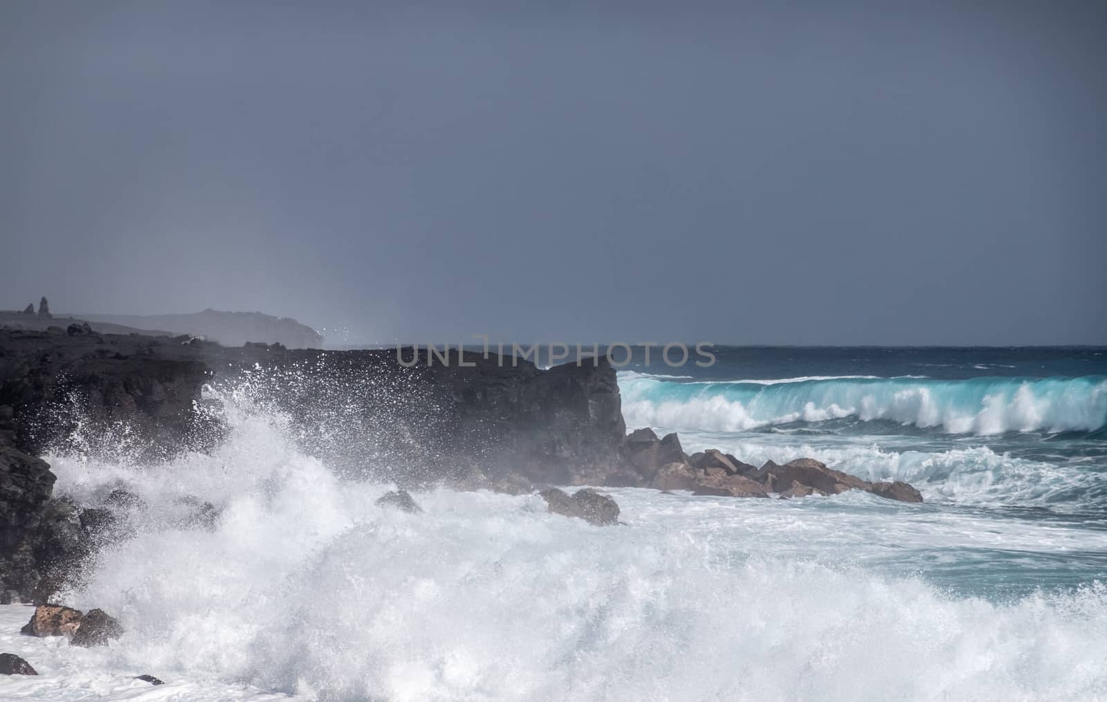 Azure waves crash on black lava coast at Kaimu Beach, Hawaii, US by Claudine