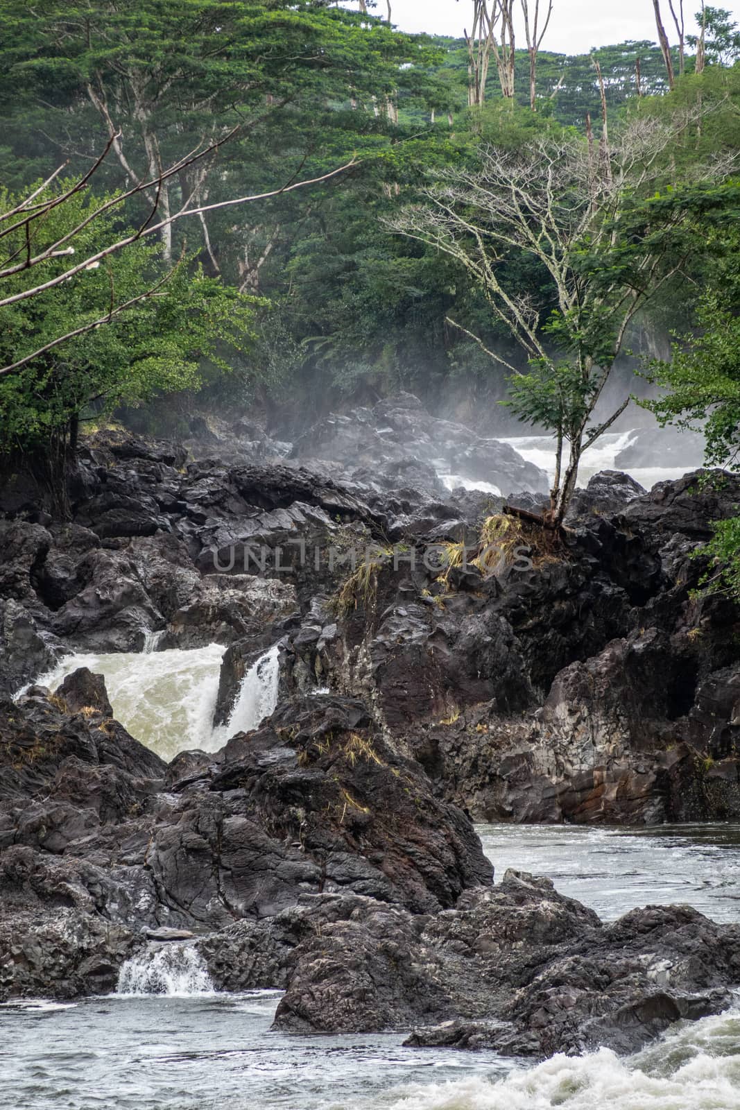 White water and lava rocks on Wailuku river above Rainbow Falls, by Claudine