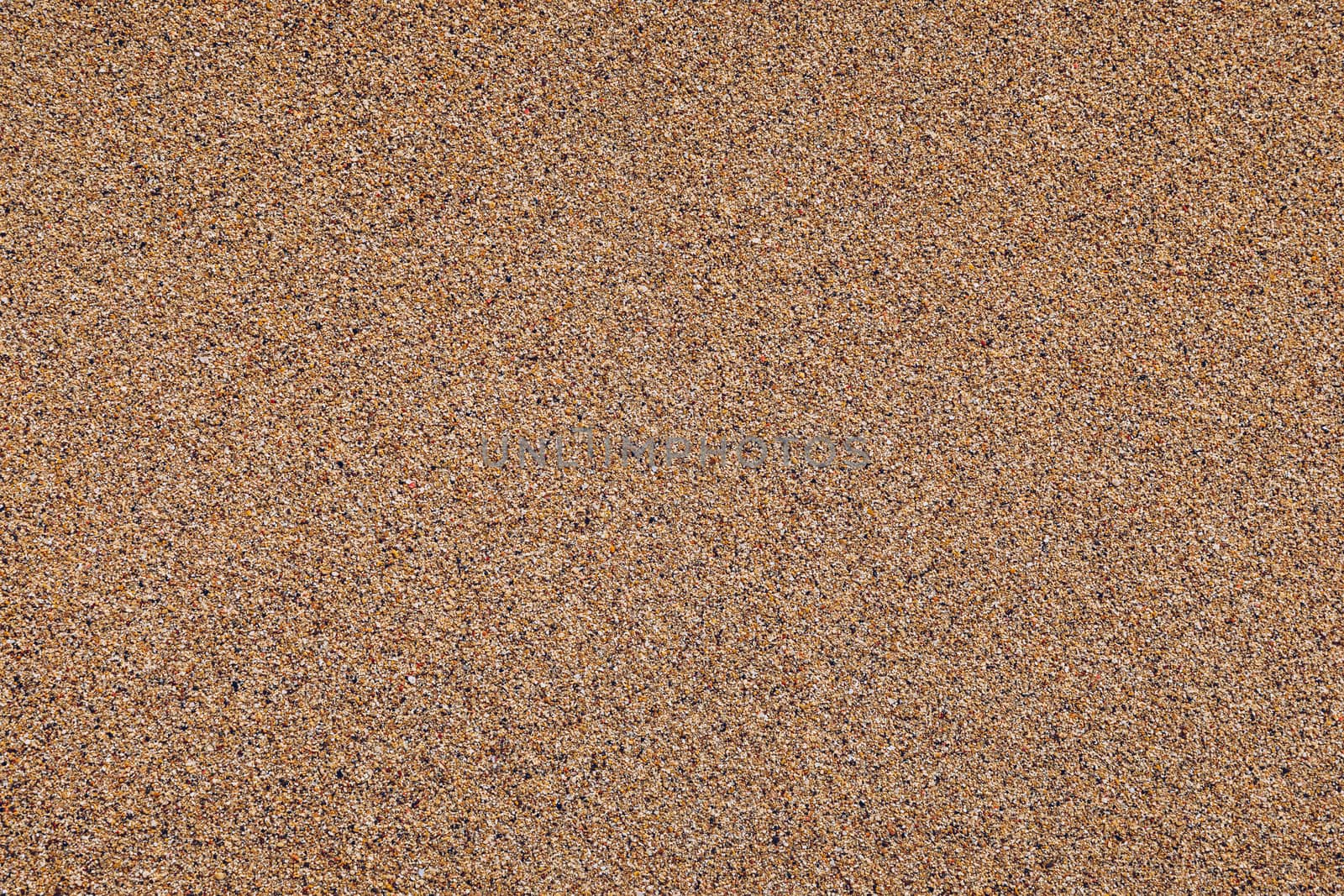Sand surface and background. Sand Texture. Brown sand. Background from fine sand. Sand background. Closeup of sand pattern of a beach in the summer.