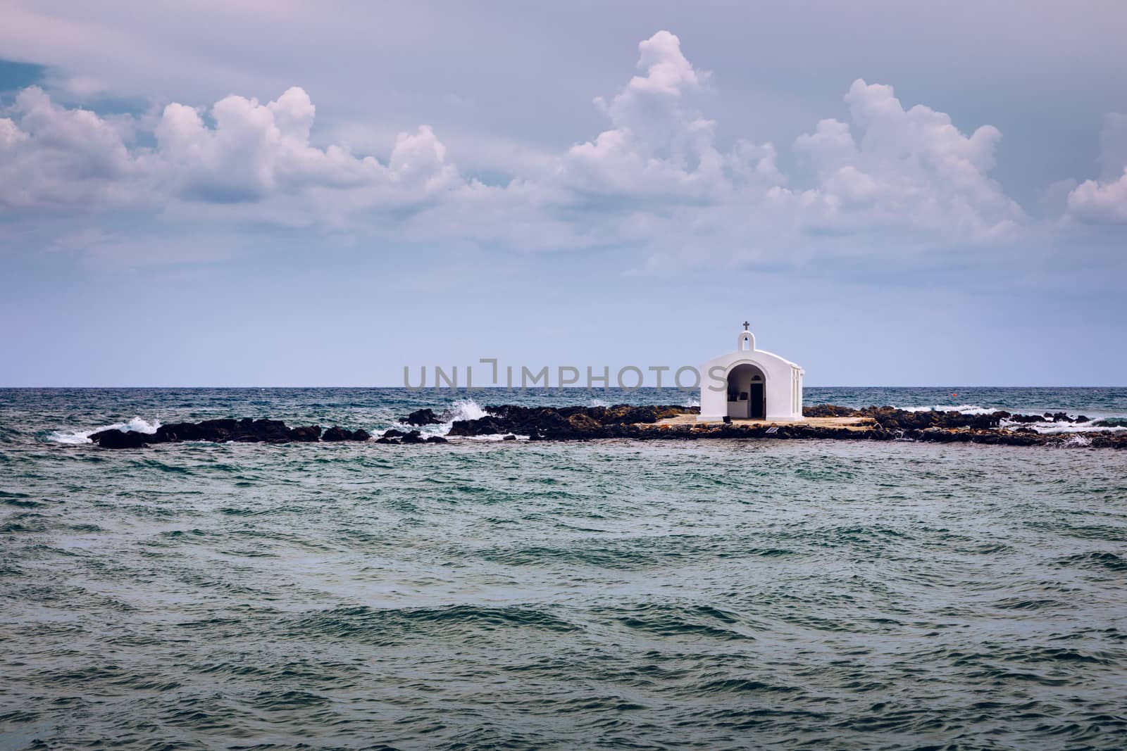 Agios Nikolaos Chapel, Georgioupoli, Crete, Greece the white chapel is built on a small rocky islet and is dedicated to Saint Nicholas, the patrons of sailors. Most famous wedding chapel. Crete.