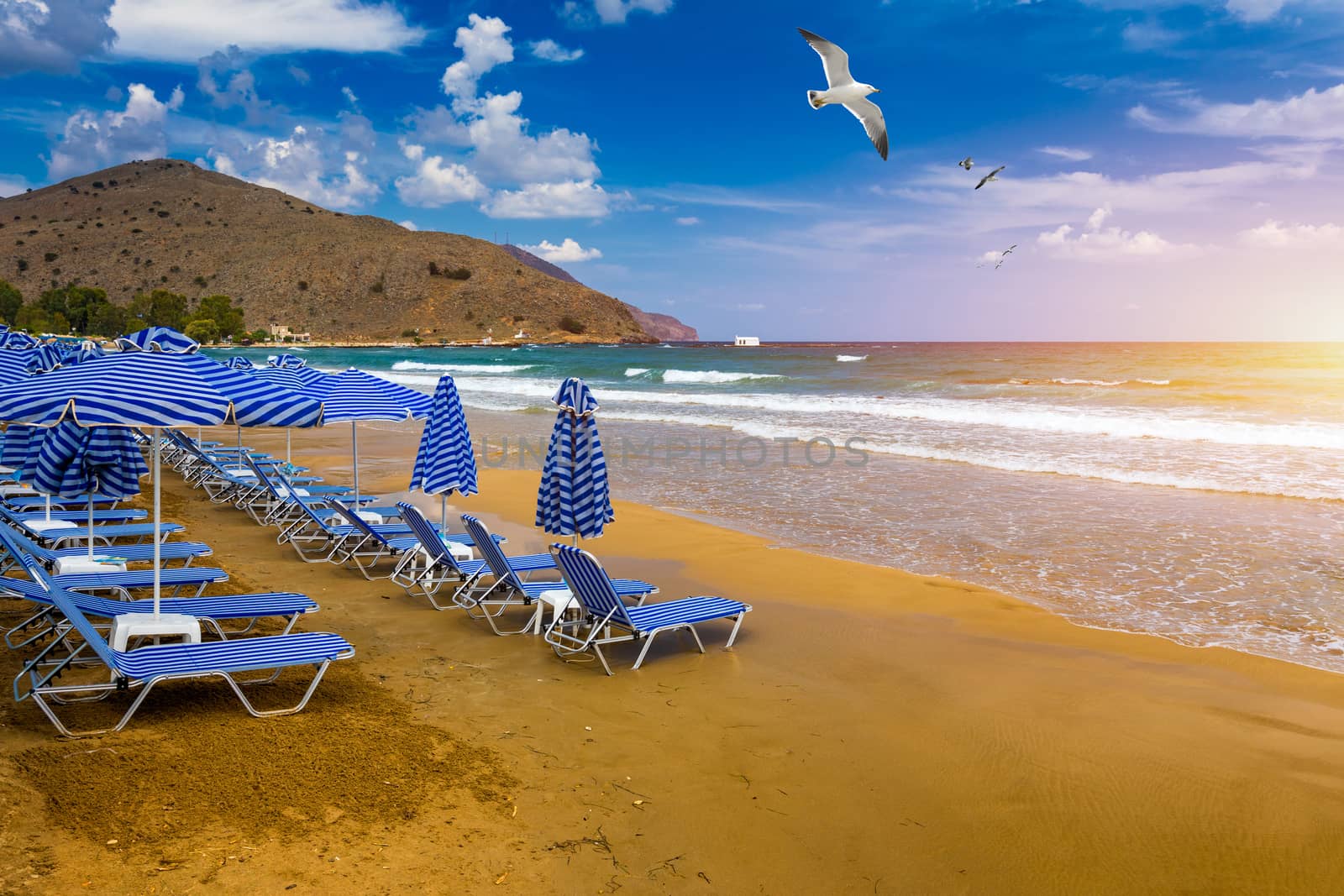 View of sunbeds awaiting tourists at the Greek island resort of Georgioupolis on Crete north coast. Georgioupoli is a resort village and former municipality in the Chania regional unit, Crete, Greece.