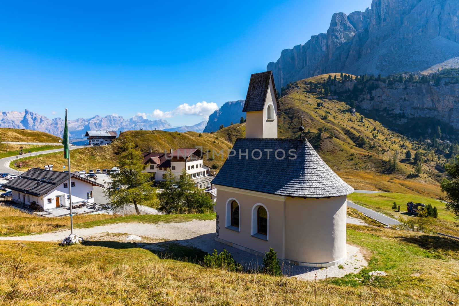 Chapel of San Maurizio at Passo Gardena, South Tyrol, Italy.  View to path to small white chapel San Maurizio and Dolomiti mountain. San Maurizio chapel on the Gardena Pass, South Tyrol, Italy.