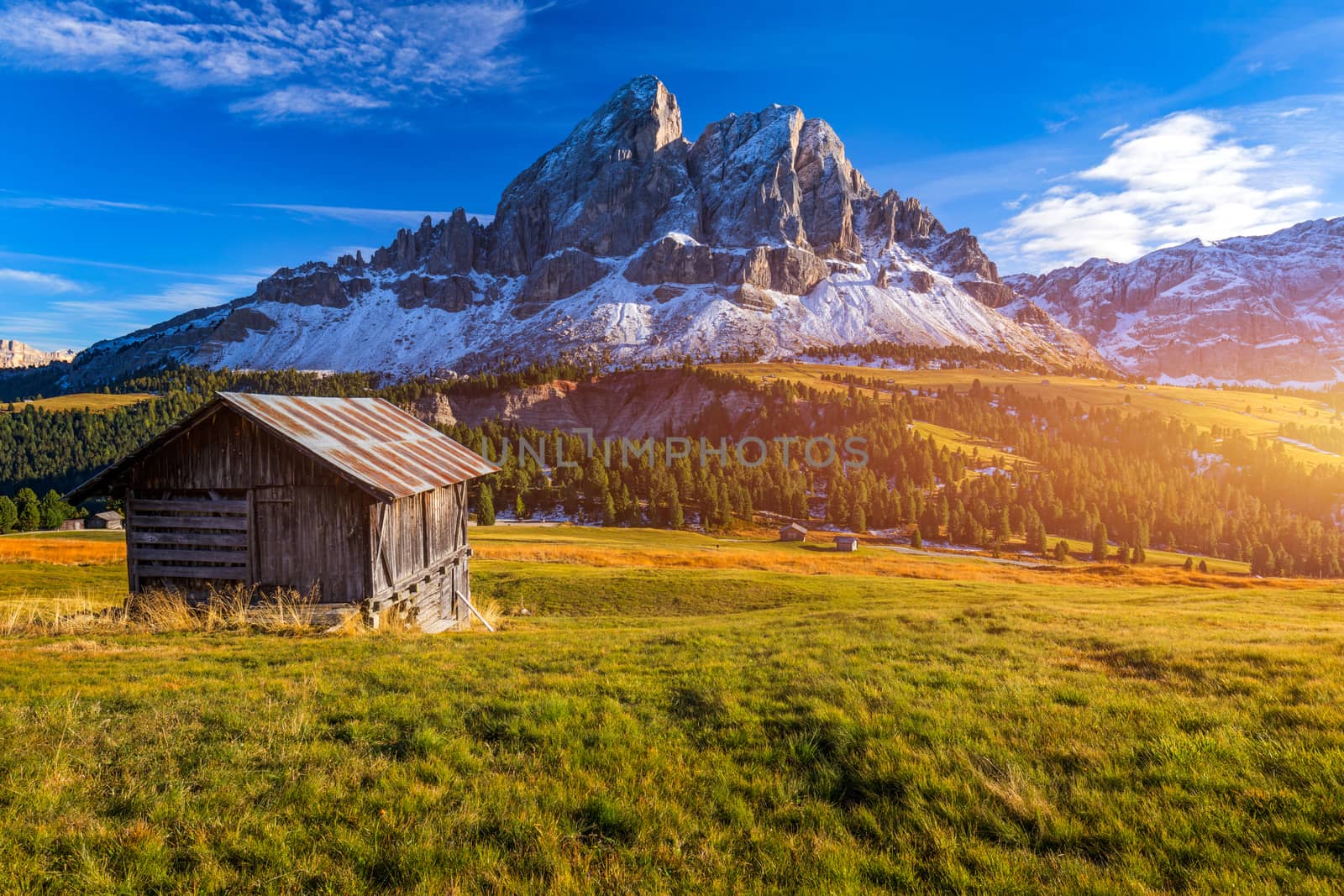 Stunning view of Peitlerkofel mountain from Passo delle Erbe in Dolomites, Italy. View of Sass de Putia (Peitlerkofel) at Passo delle Erbe, with wooden farm houses, Dolomites, South Tyrol, Italy.