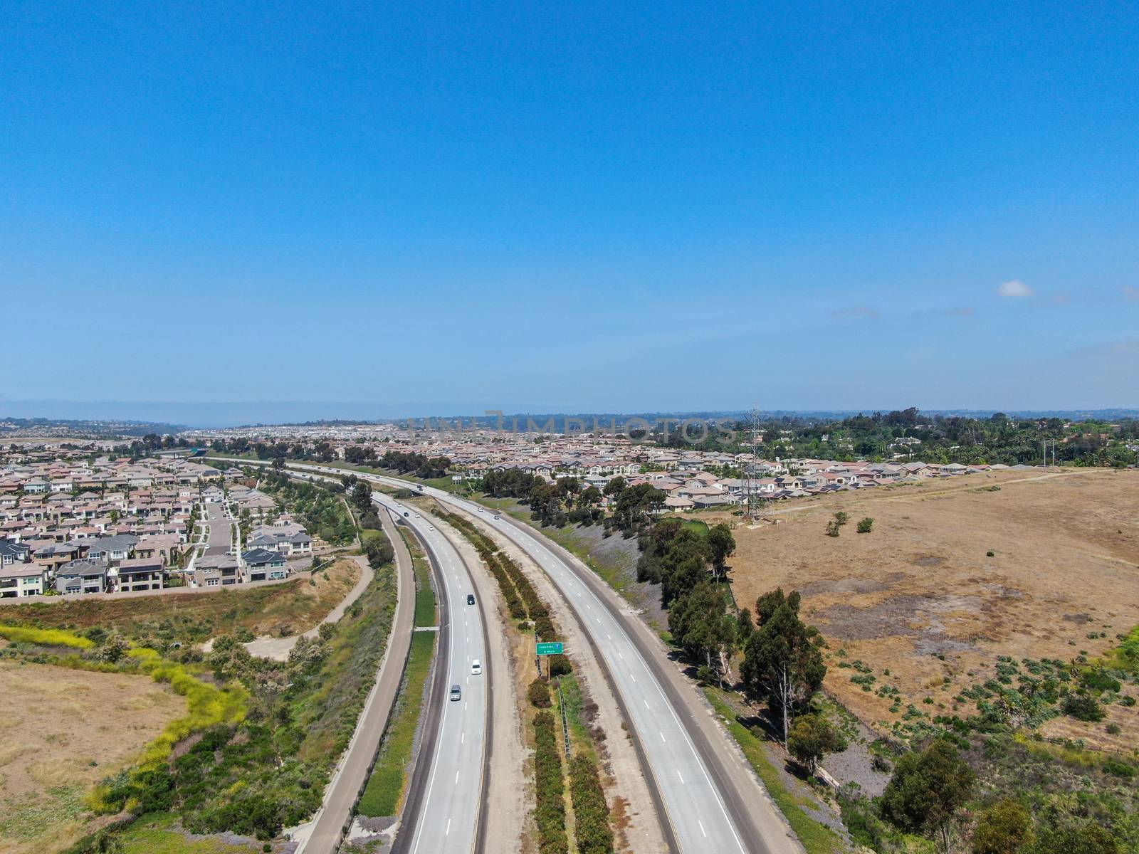 Aerial view of highway, freeway road with vehicle in movement by Bonandbon