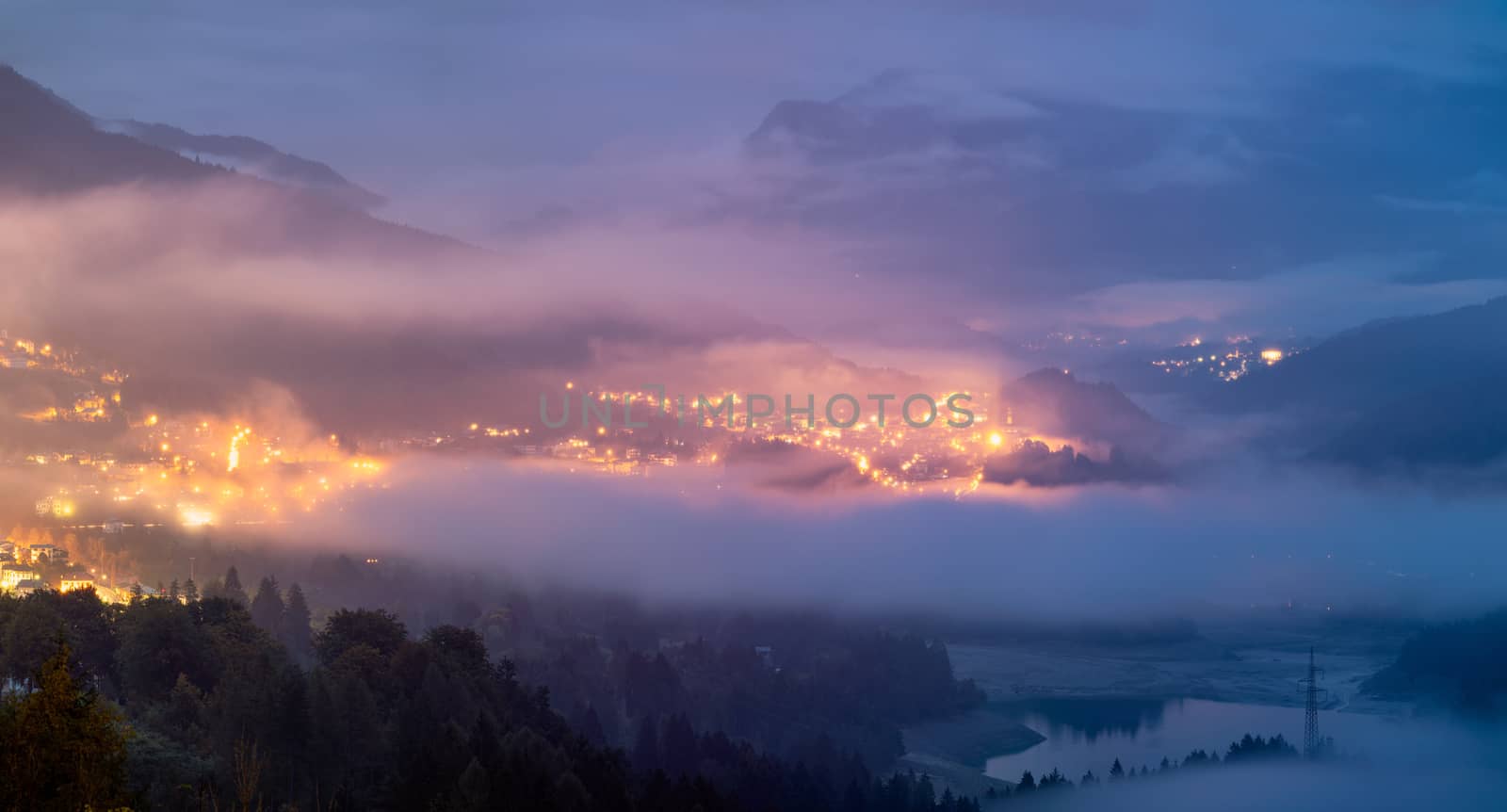 Panoramic view of lake of Centro Cadore in the Alps in Italy, Dolomites, near Belluno. View of Lake Calalzo, Belluno, Italy. Lake of Centro Cadore in the Alps in Italy, near Belluno.