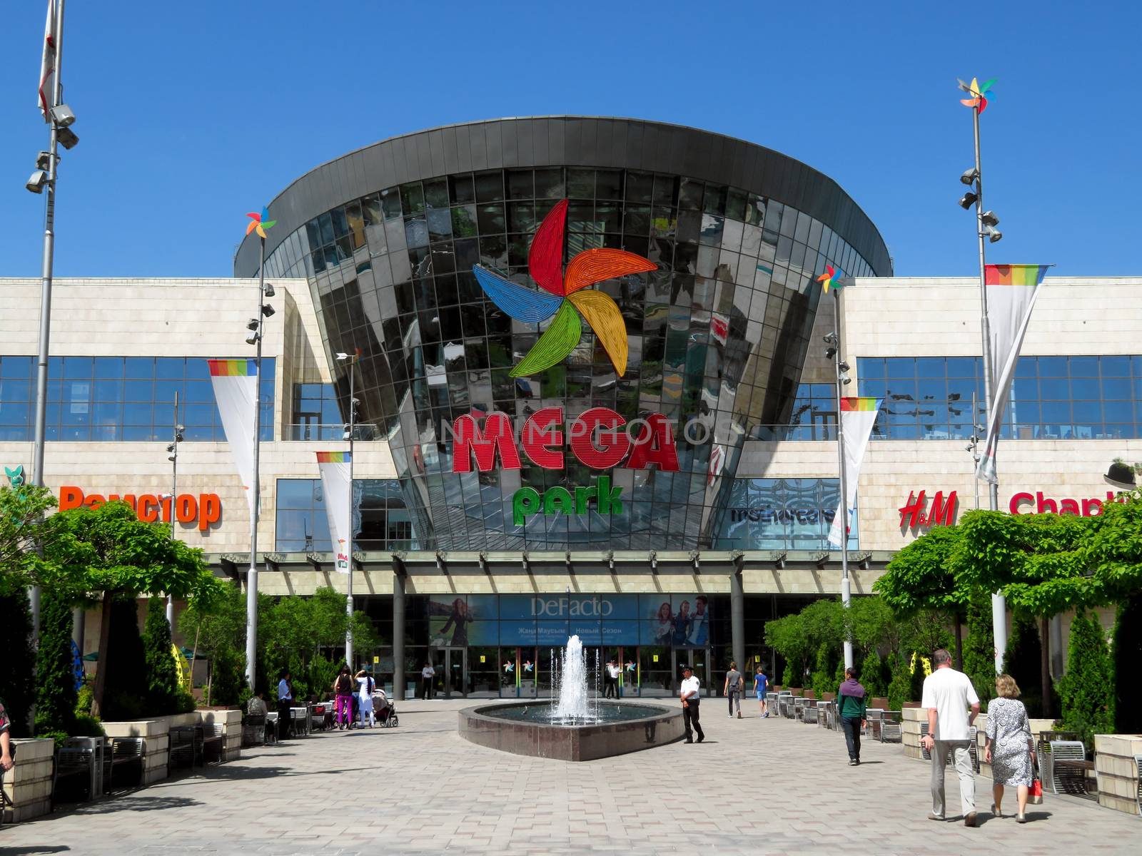 ALMATY, KAZAKHSTAN - June 15, 2019: Shopping and entertainment center Mega Park in Almaty, Kazakhstan. Opened in 2015, it is the largest department store in Almaty. Unidentified people are outside.