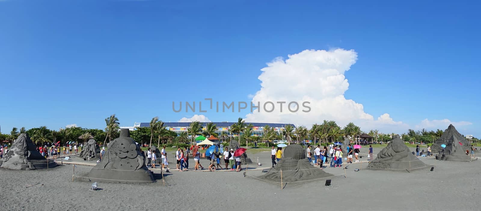 KAOHSIUNG, TAIWAN -- JULY 29, 2018: Visitors enjoy the sand sculptures at the 2018 Chijin Island Black Sand Festival.