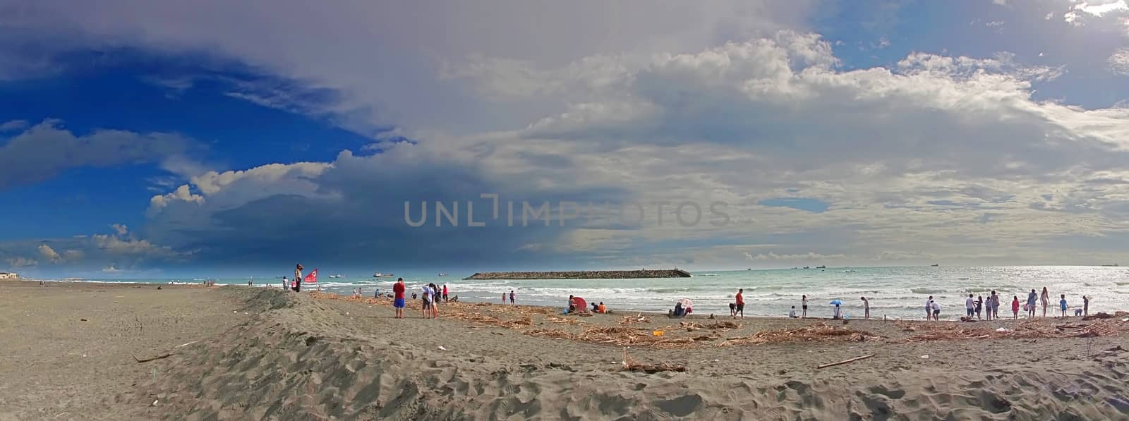 KAOHSIUNG, TAIWAN -- AUGUST 12, 2015: People visit the beach on Chijin Island after typhoon Sudelor battered Taiwan and dumped a lot of debris on the shore.
