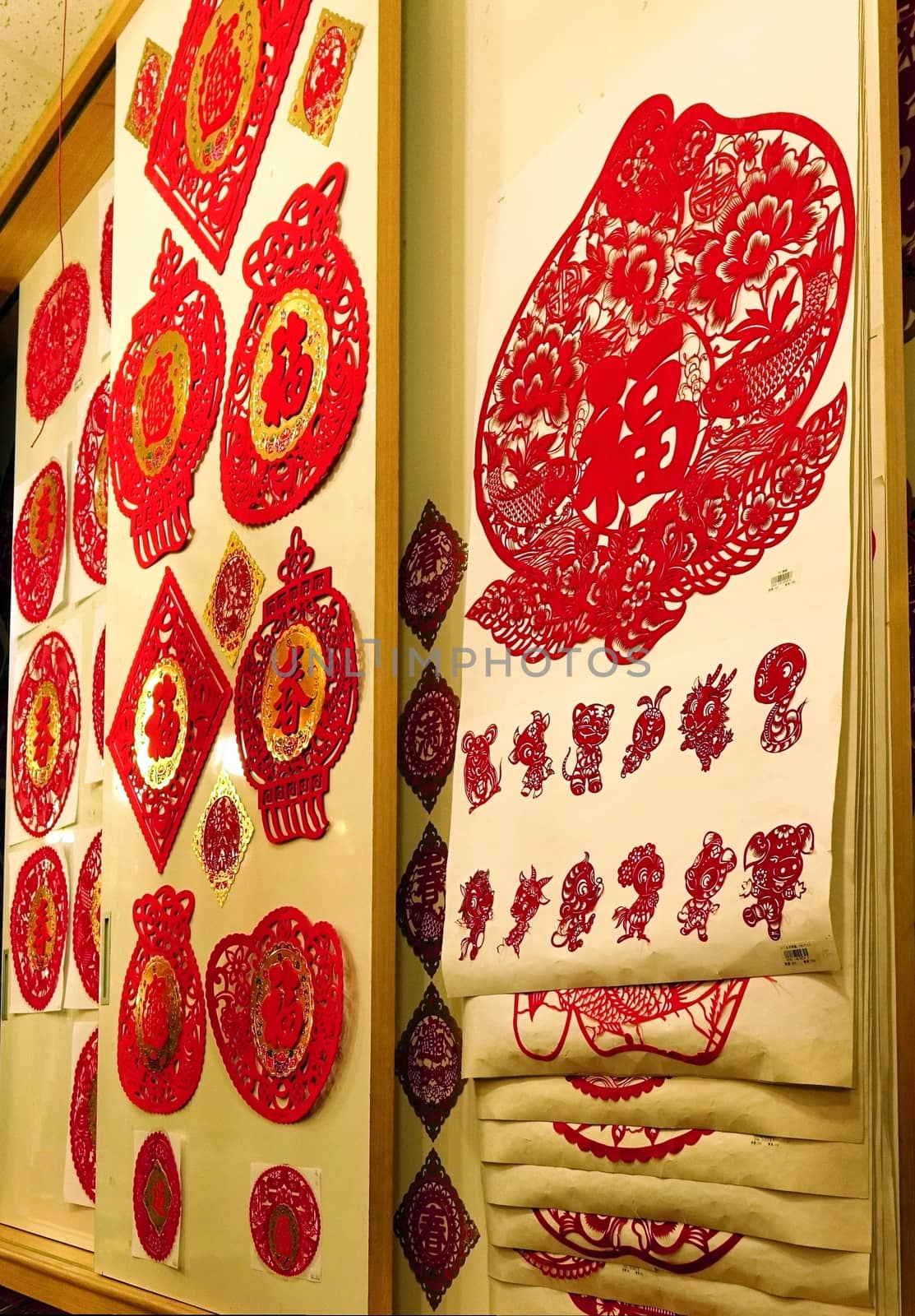 KAOHSIUNG, TAIWAN -- JANUARY 22, 2015: A store sells bright red paper cuts and printed couplets and proverbs for the Chinese New Year.