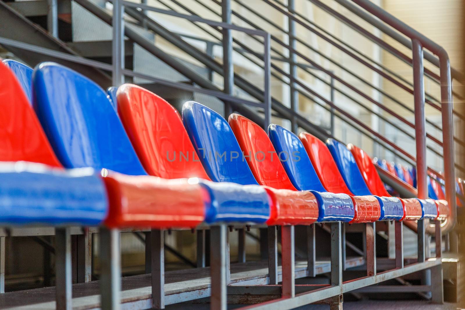 multi-colored plastic seats on the podium in the sports complex