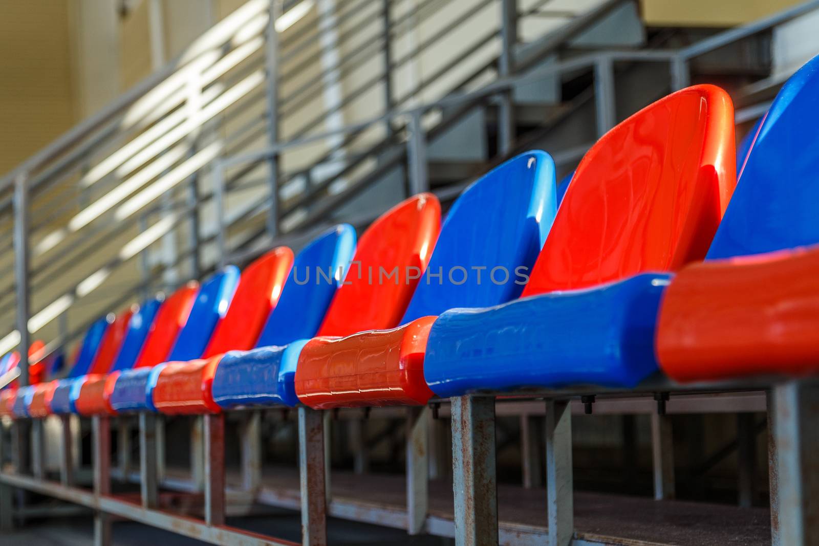 multi-colored plastic seats on the podium in the sports complex