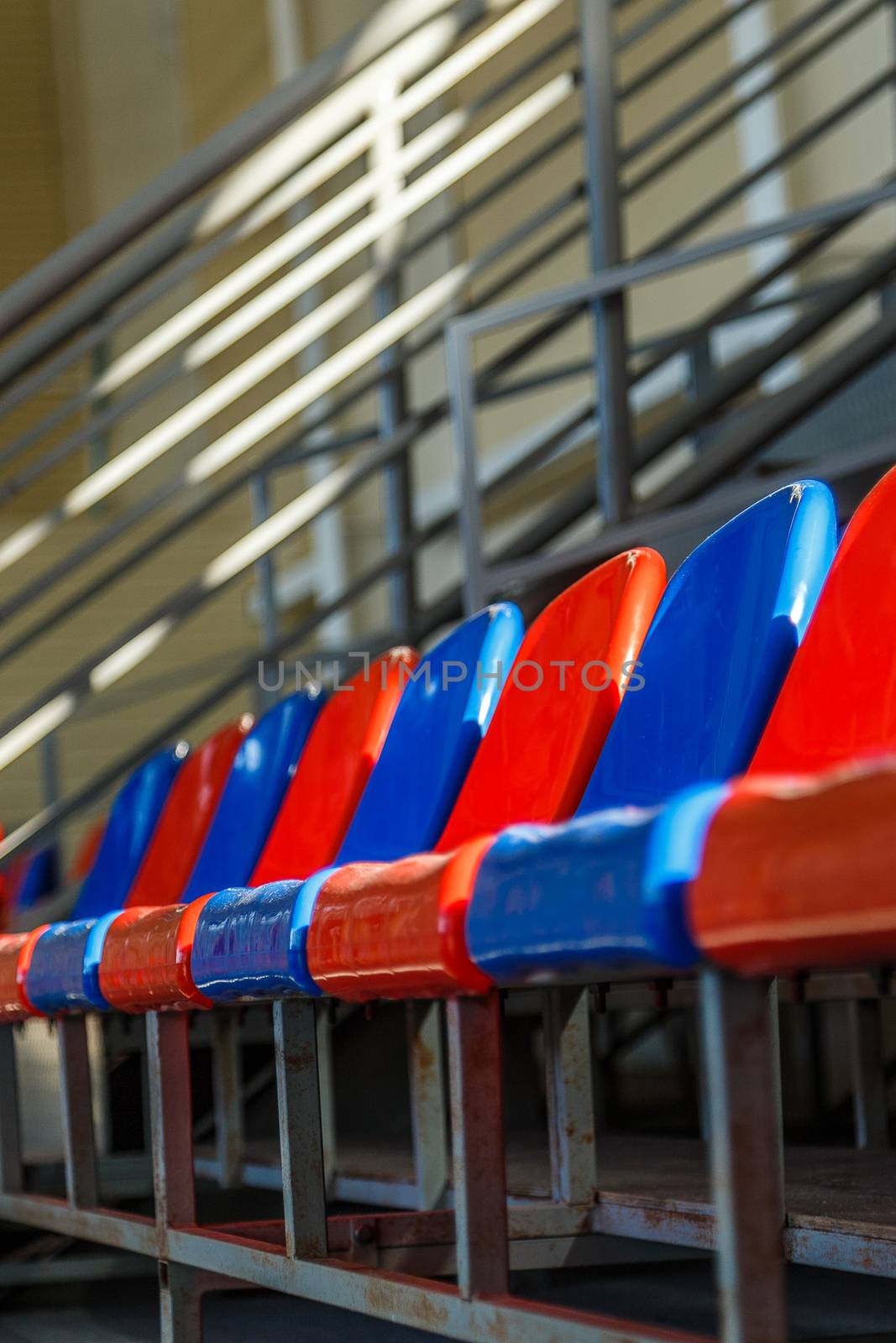 multi-colored plastic seats on the podium by VADIM