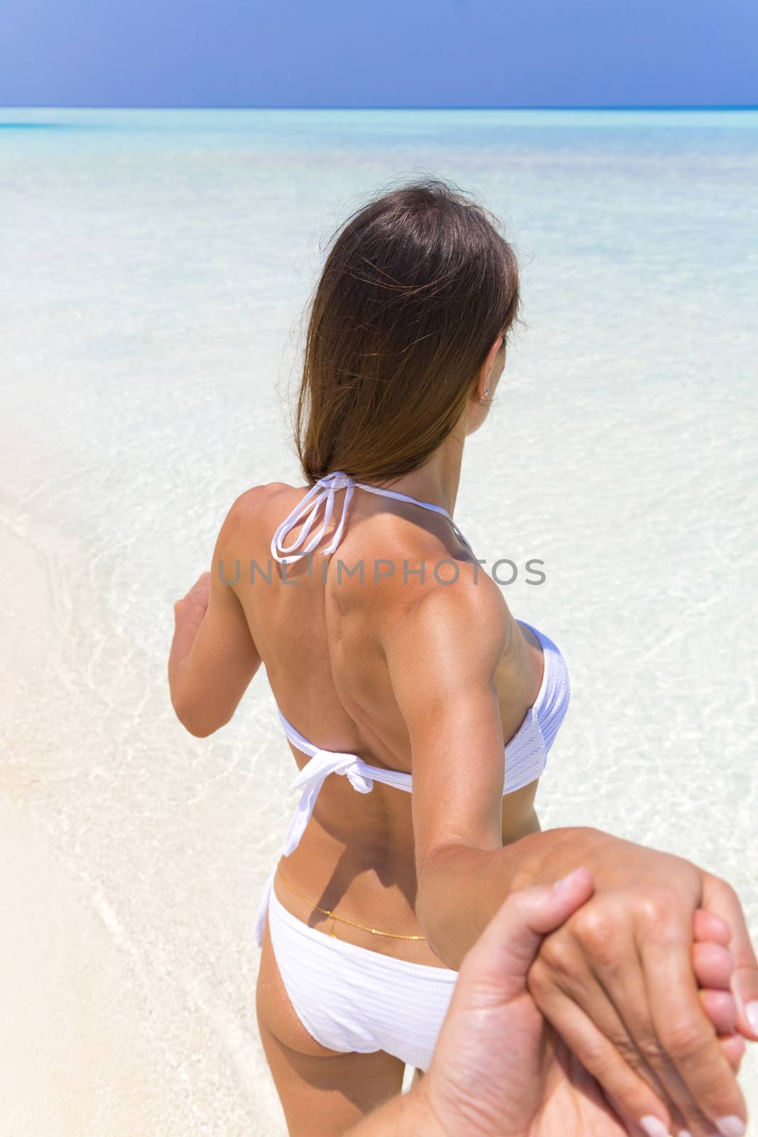 Fit woman running to a clear water. Hand to hand.