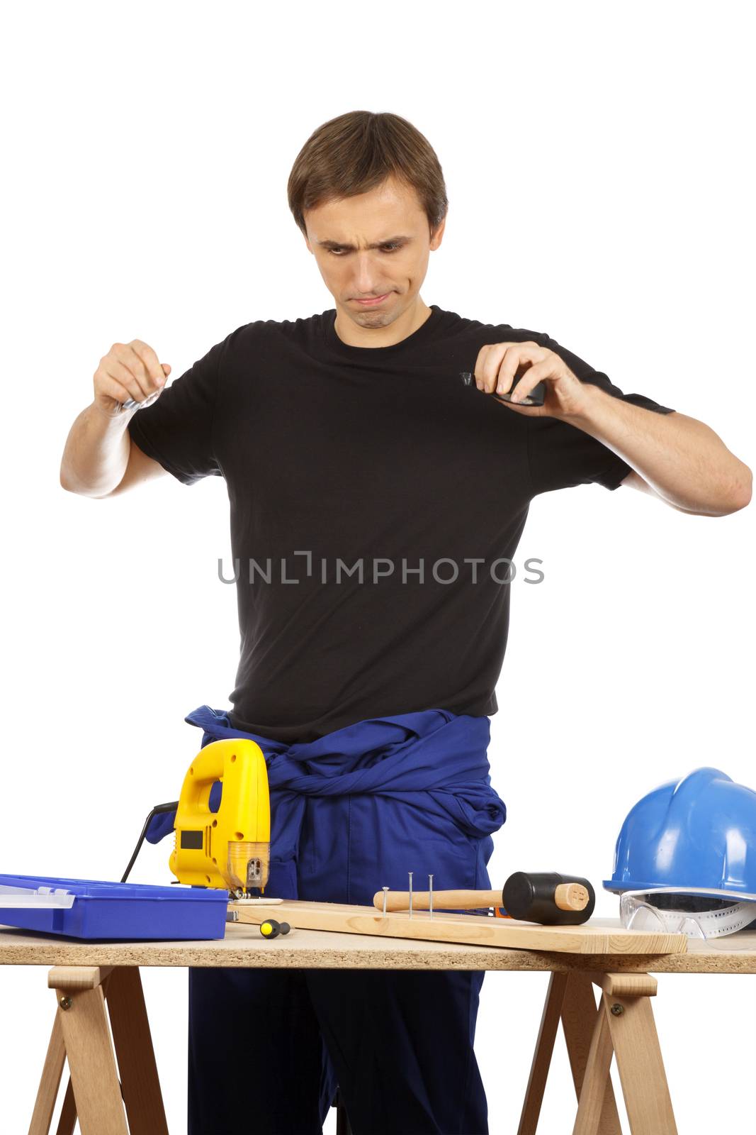 Man working with tools and wood. Over white.