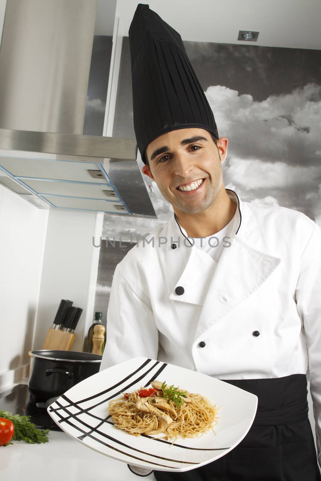 Chef showing proudly a dish of rice noodles.