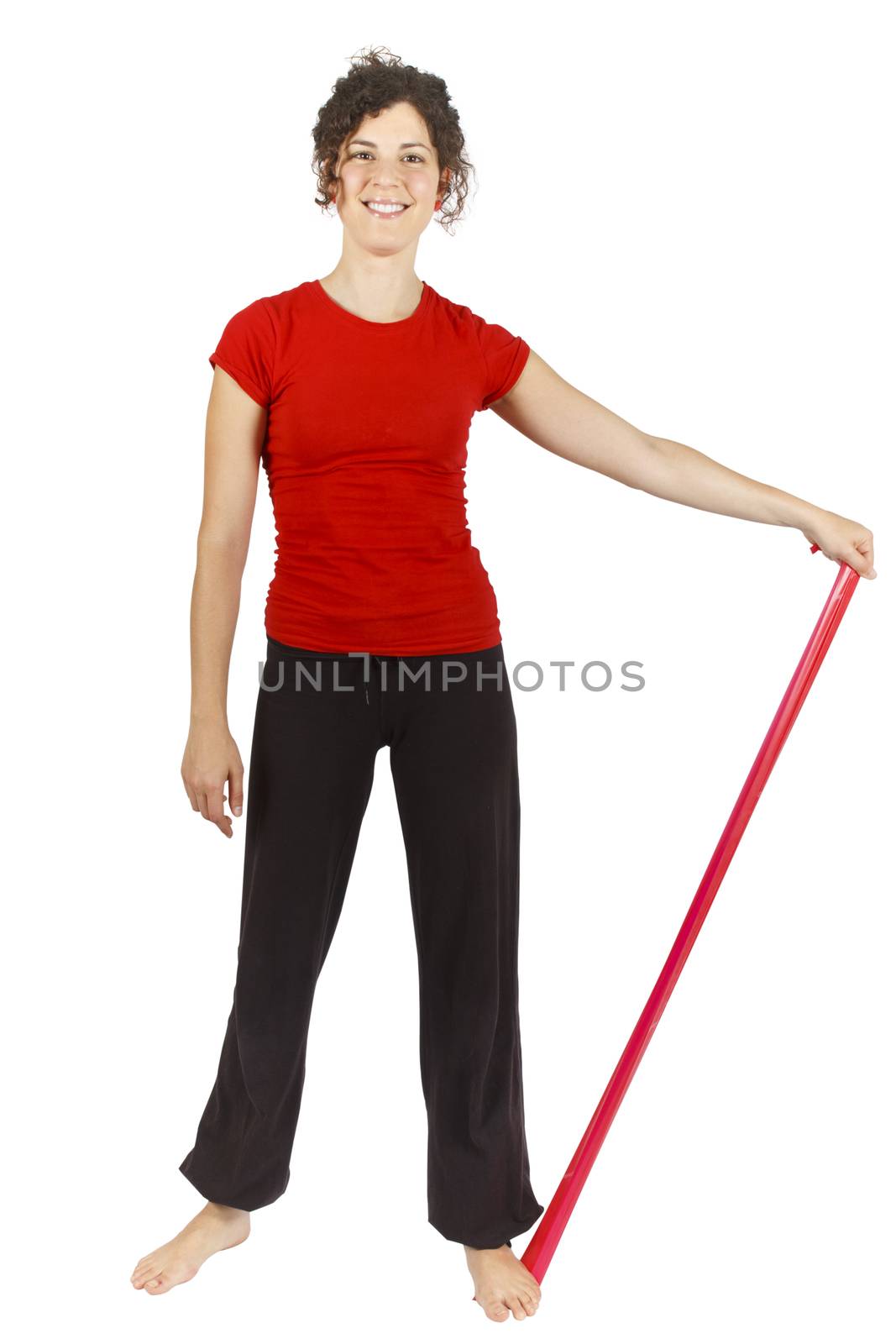 Young woman doing some exercise with an elastic ribbon.