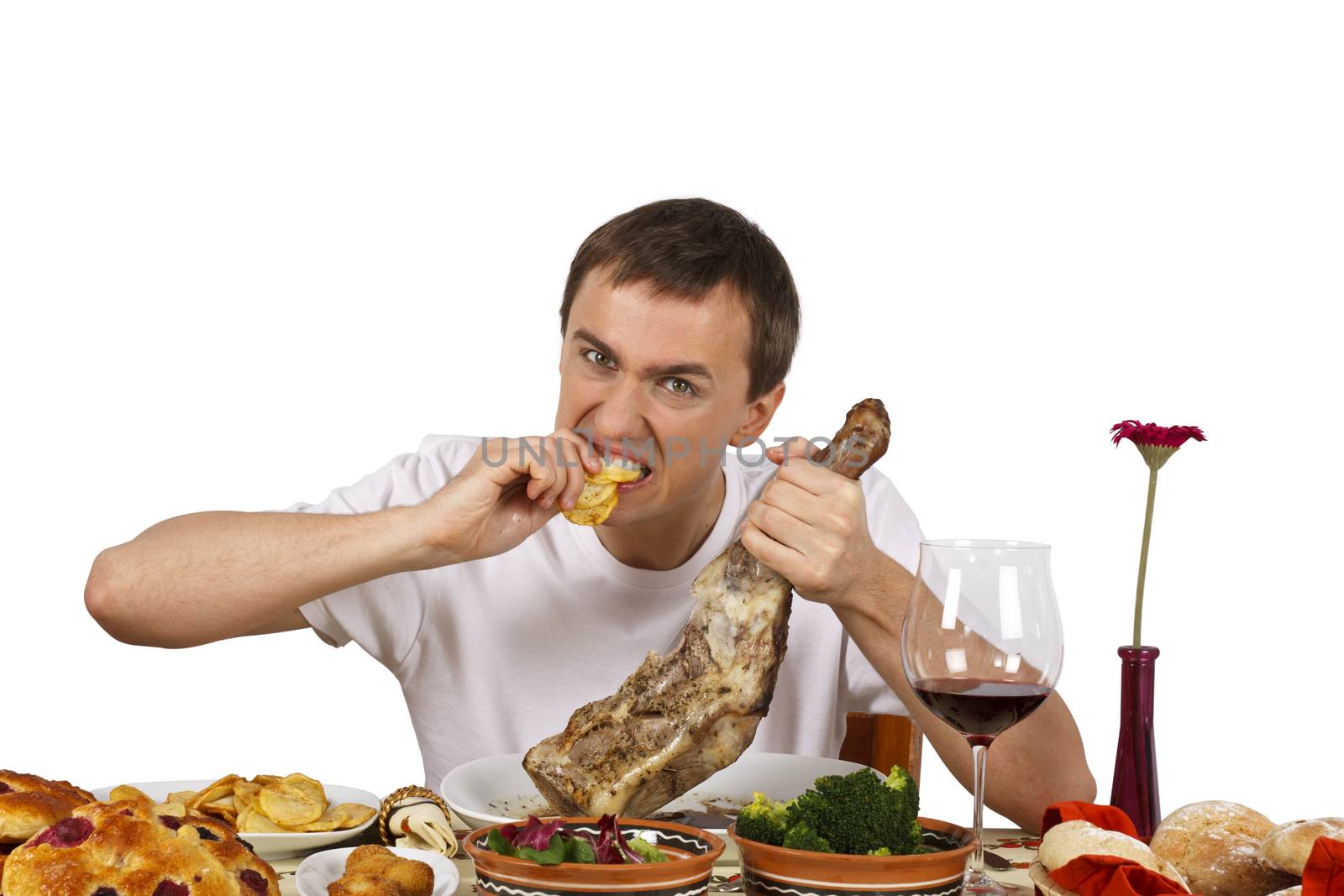 Young man biting french fries. Isolated of white background.