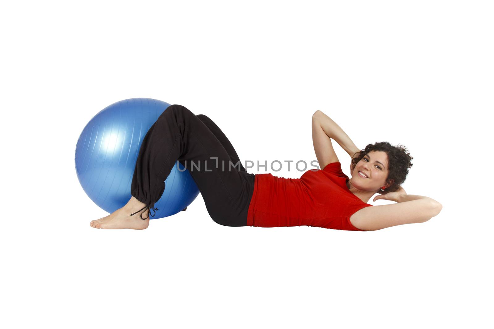 Young woman doing some sit-ups with a blue yoga ball.