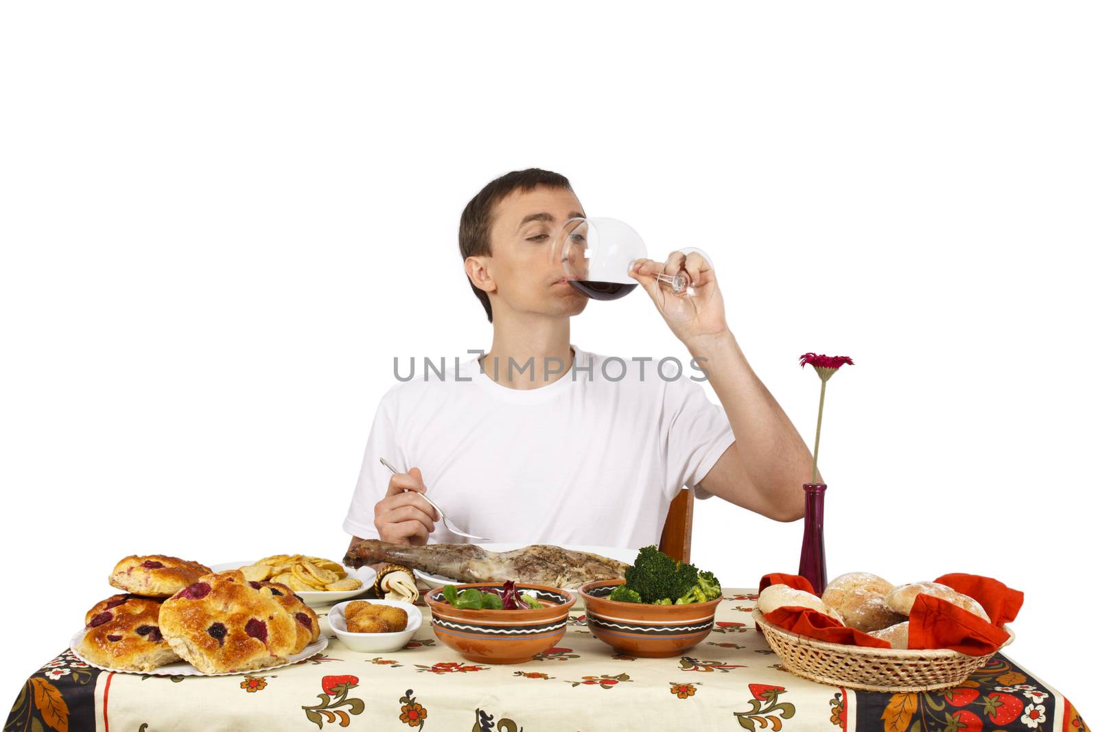 Young man drinking a glass of red wine. Isolated of white background.