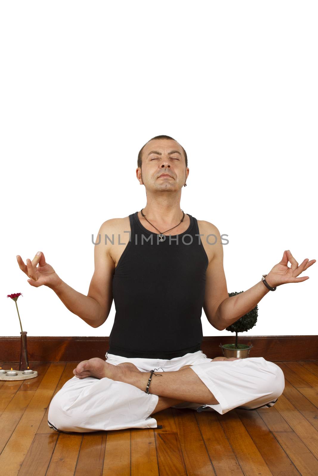 Young man sitting on floor doing some yoga exercise.