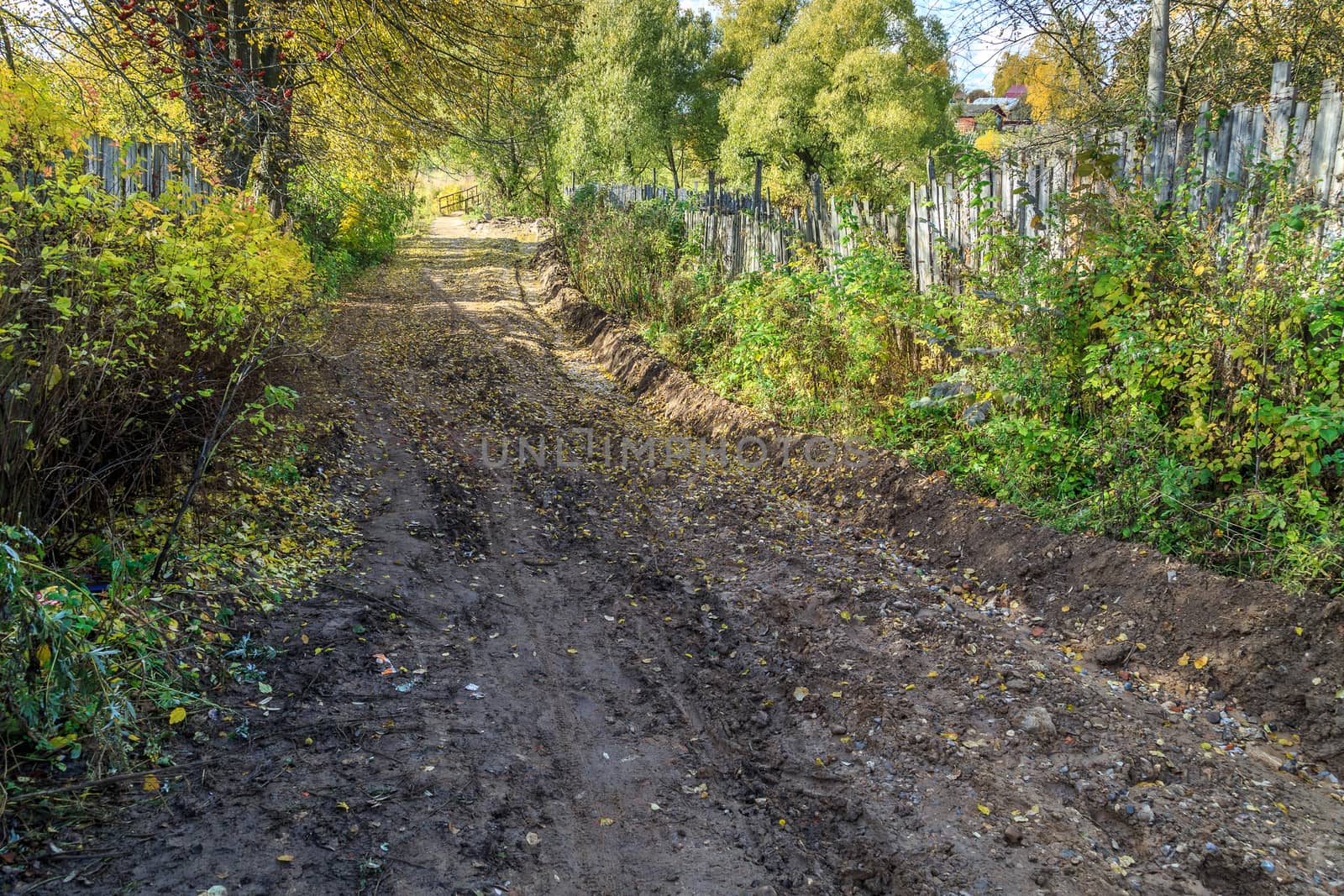 pavement in a provincial Russian city in poor condition, puddles and dirt