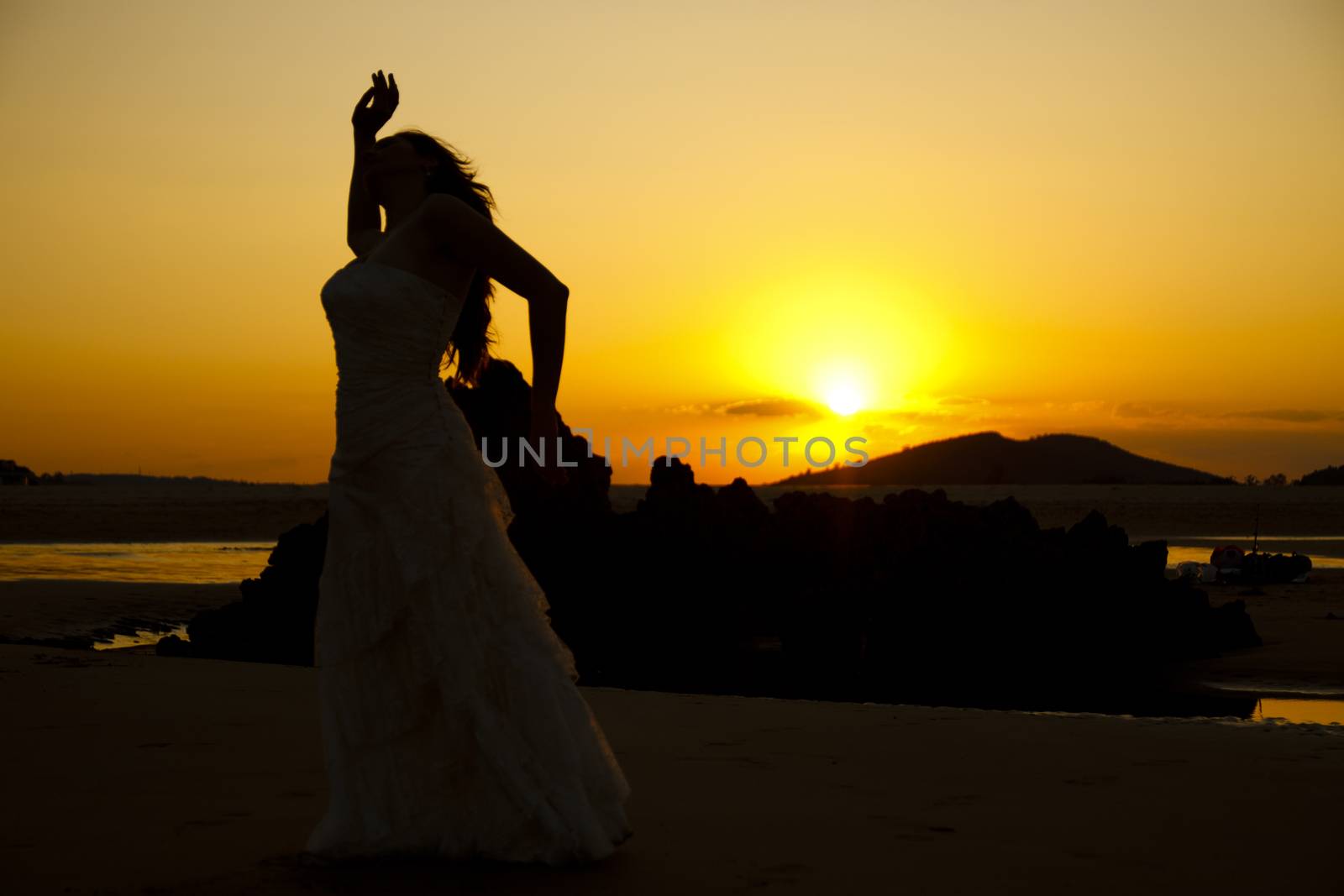 Bride dancing at sunset. Low light