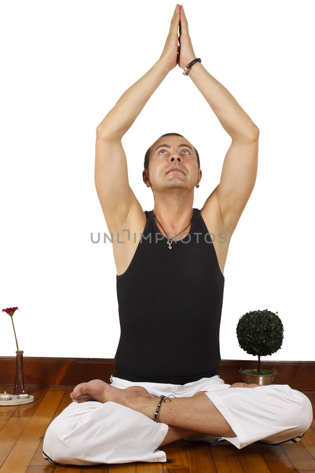 Young man sitting on floor doing some yoga exercise.
