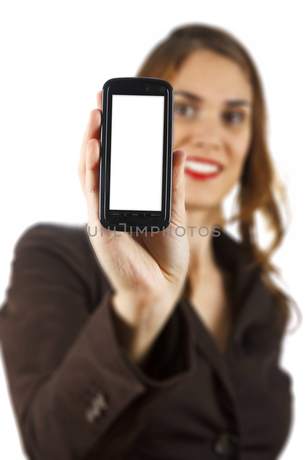 Businesswoman out of focus at background showing a mobile phone with white display. Isolated on white background.