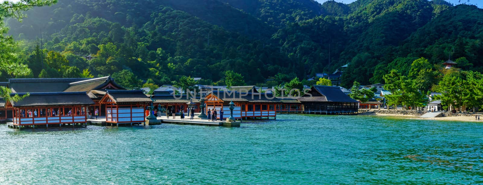 Miyajima, Japan - October 13, 2019: Panoramic view of the Itsukushima Shrine, at high tide, with visitors, in Miyajima (Itsukushima) Island, Japan