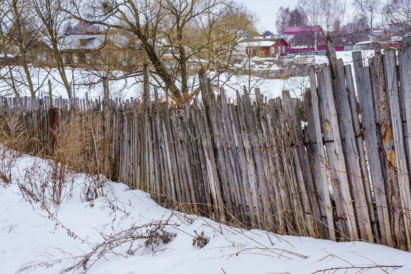 old fence around the garden of nailing boards