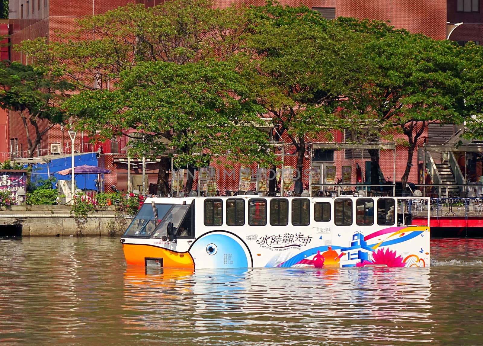 KAOHSIUNG, TAIWAN - MAY 21, 2017: An amphibious tourist bus transports visitors on the Love River in Kaohsiung City.