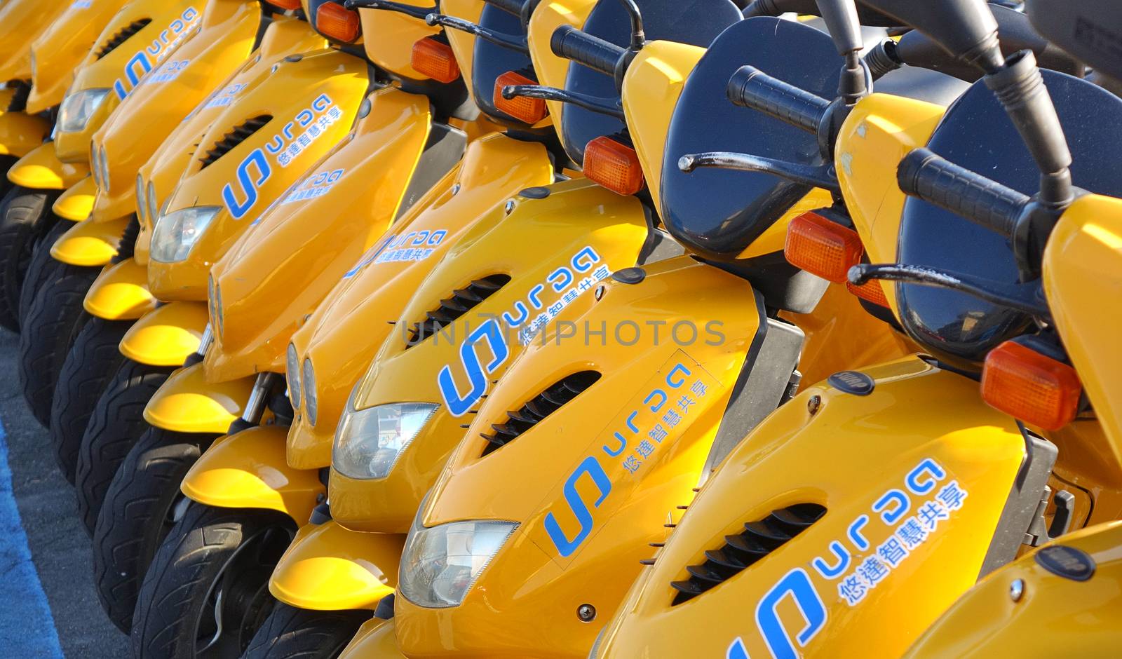 KAOHSIUNG, TAIWAN -- DECEMBER 14, 2019: A row of electric scooters that are available for rent.
