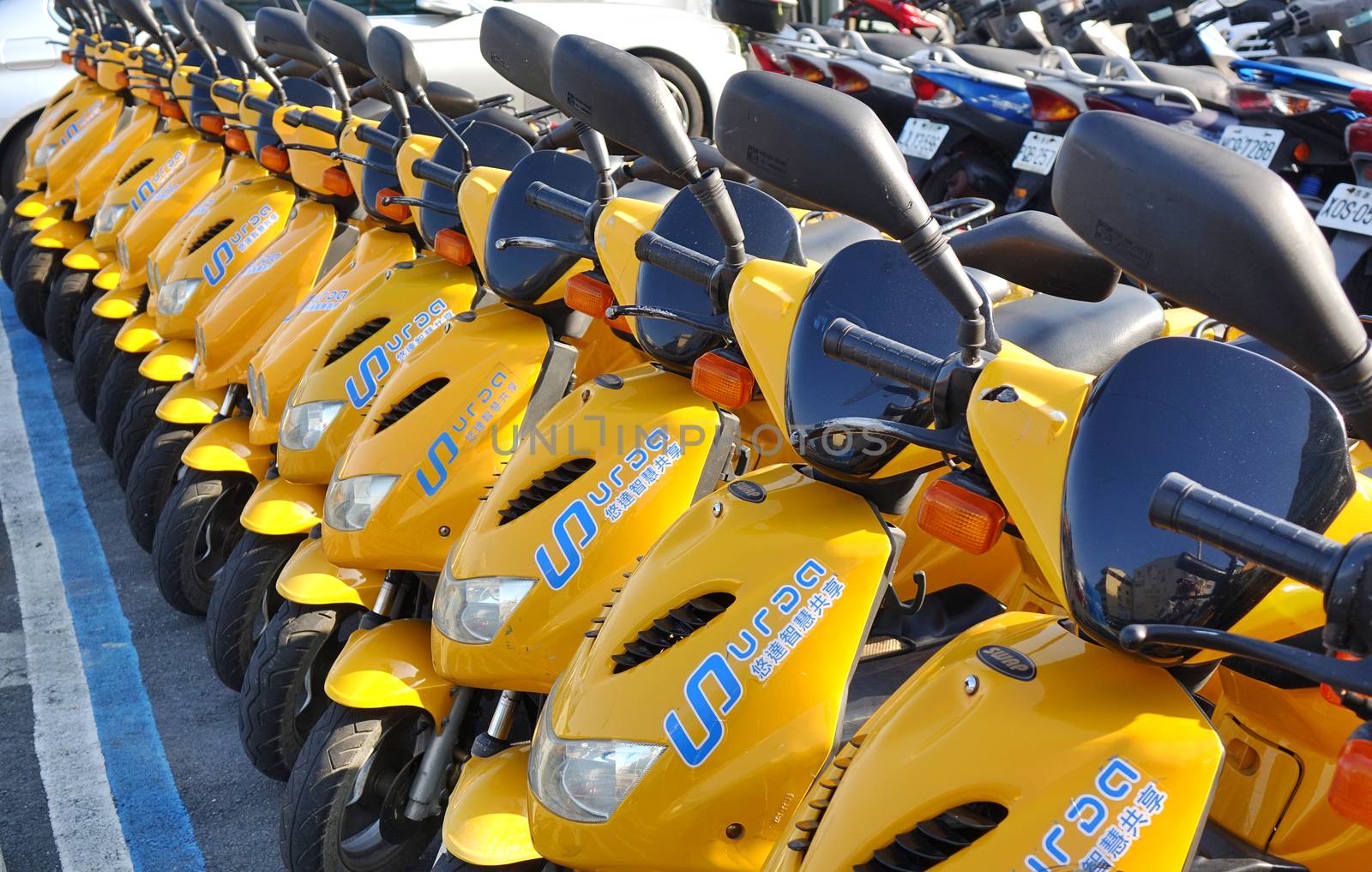 KAOHSIUNG, TAIWAN -- DECEMBER 14, 2019: A row of electric scooters that are available for rent.