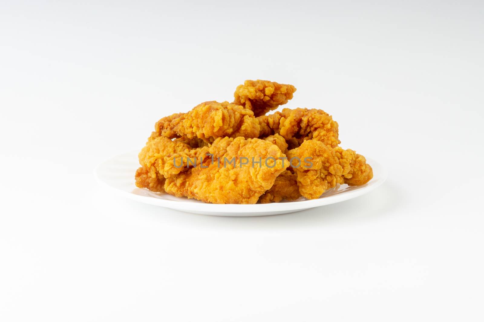 Fried breaded chicken fillet isolated on white background 