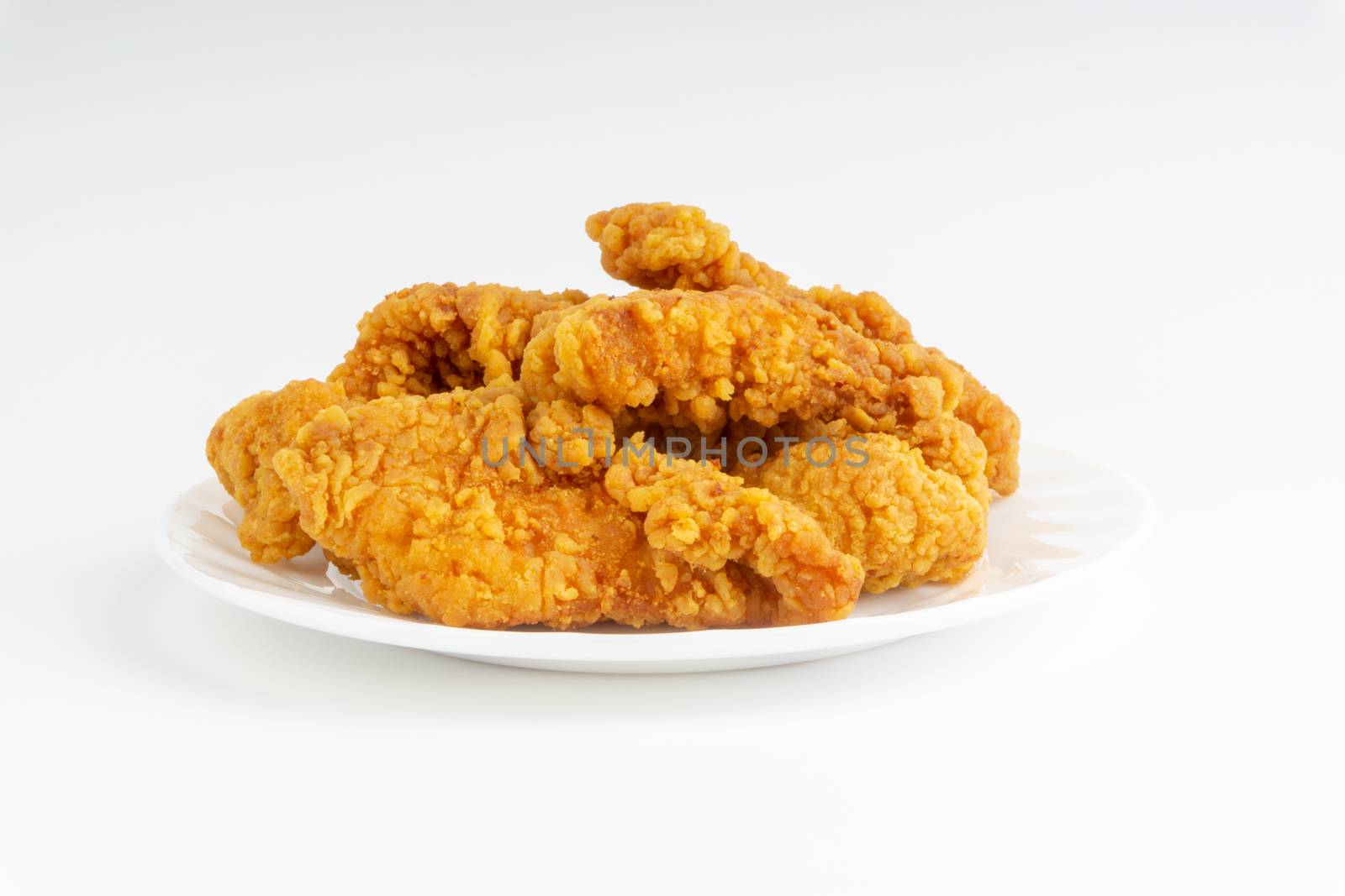 Fried breaded chicken fillet isolated on white background 