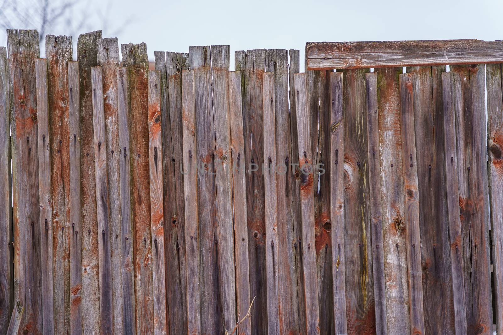 old fence around the garden of nailing boards