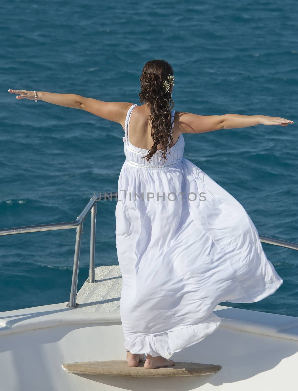 Bride on the bow of a boat by paulvinten