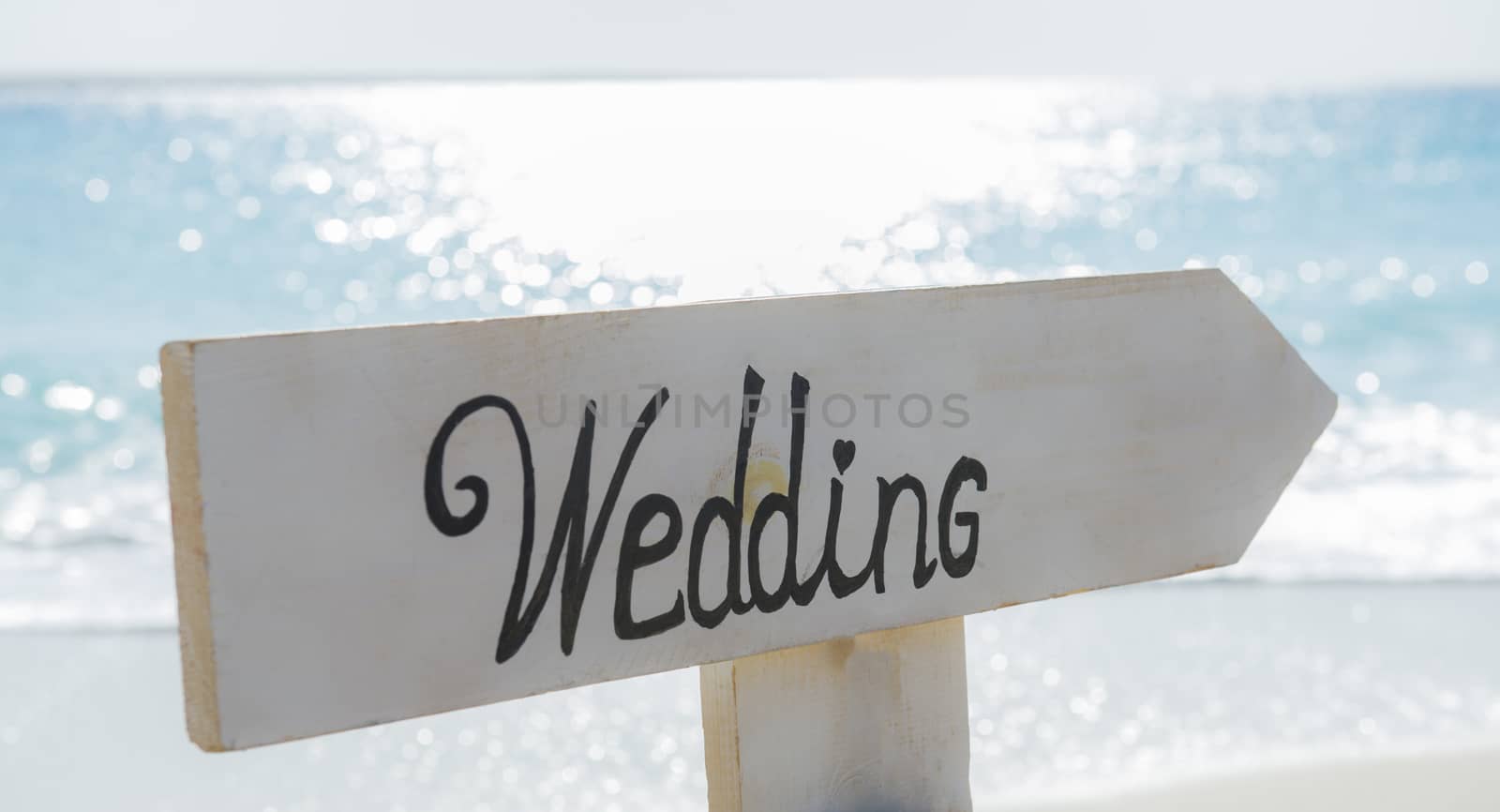 Closeup of wedding sign on tropical island beach paradise with ocean in background