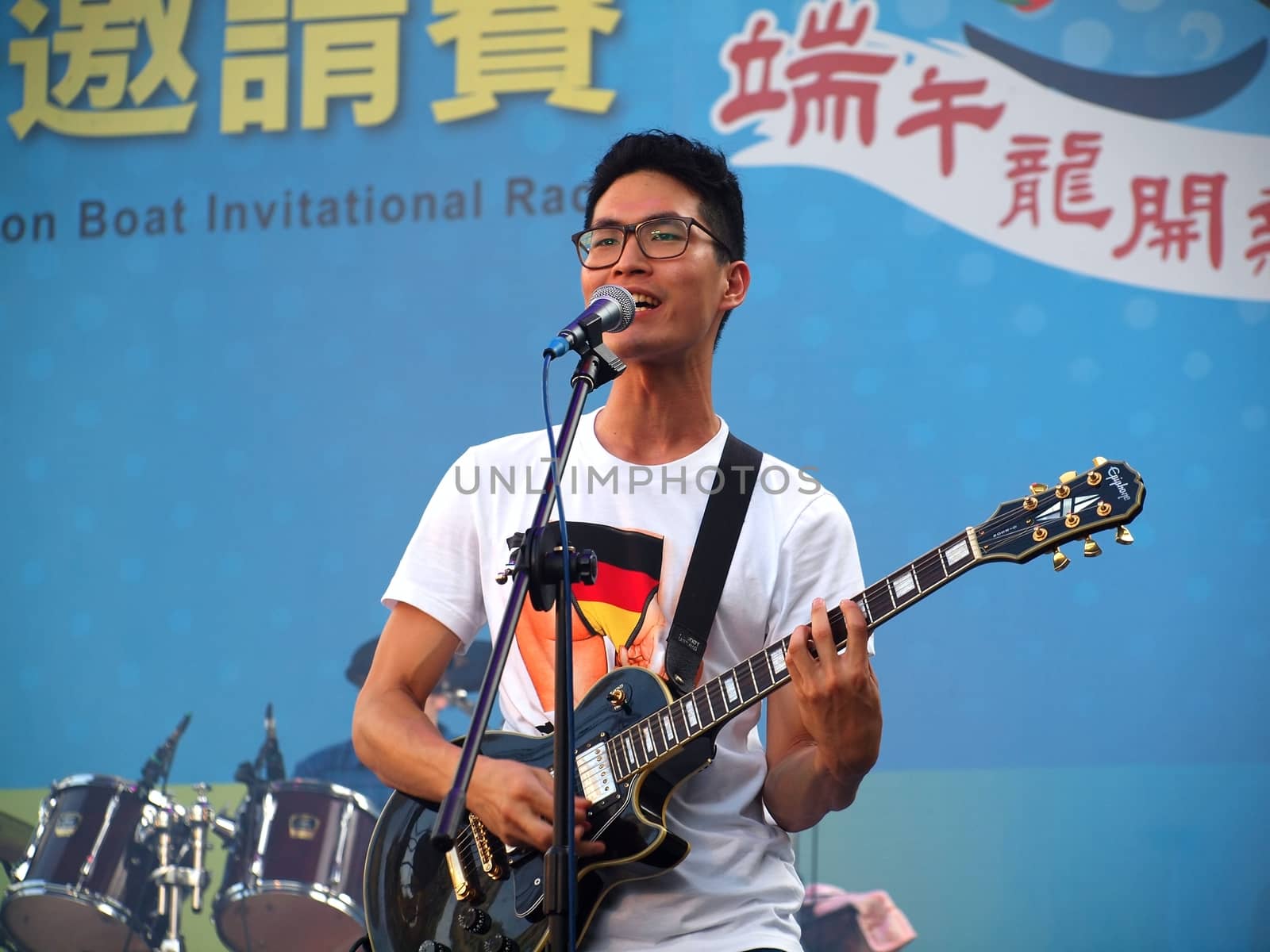 KAOHSIUNG, TAIWAN - JUNE 23: Local pop group Fleabags entertains visitors to the 2012 Dragon Boat Festival along the Love River on June 23, 2012 in Kaohsiung