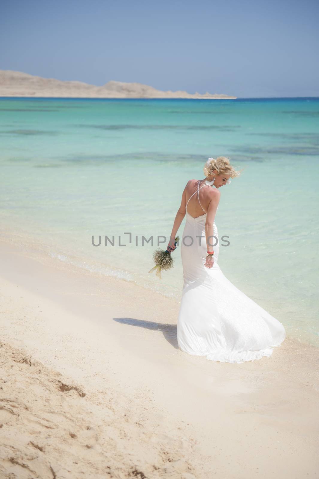Beautiful bride on a tropical beach wedding day by paulvinten