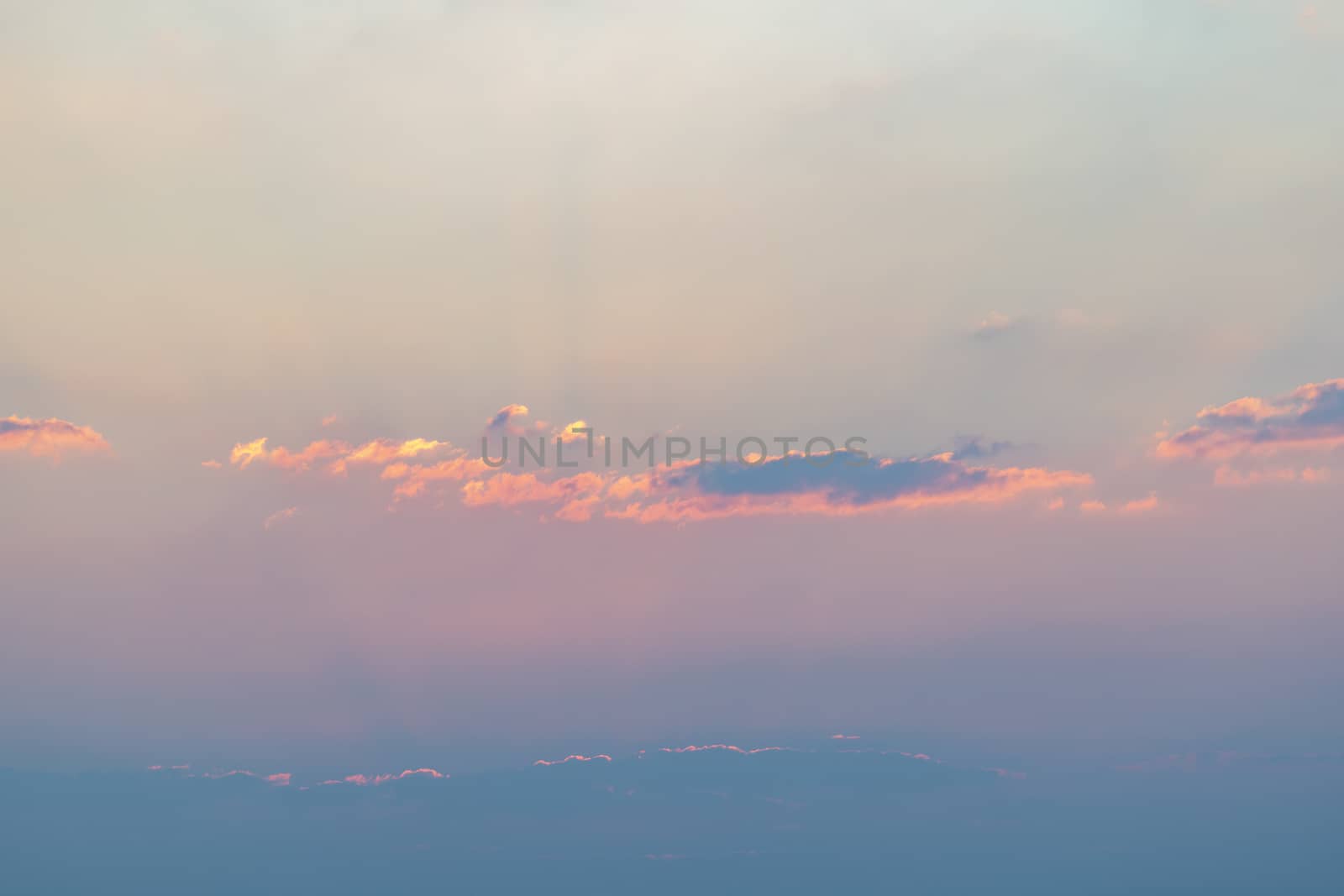 Colorful clouds in the sky for background. Pastel colors sky with yellow, orange and black clouds.