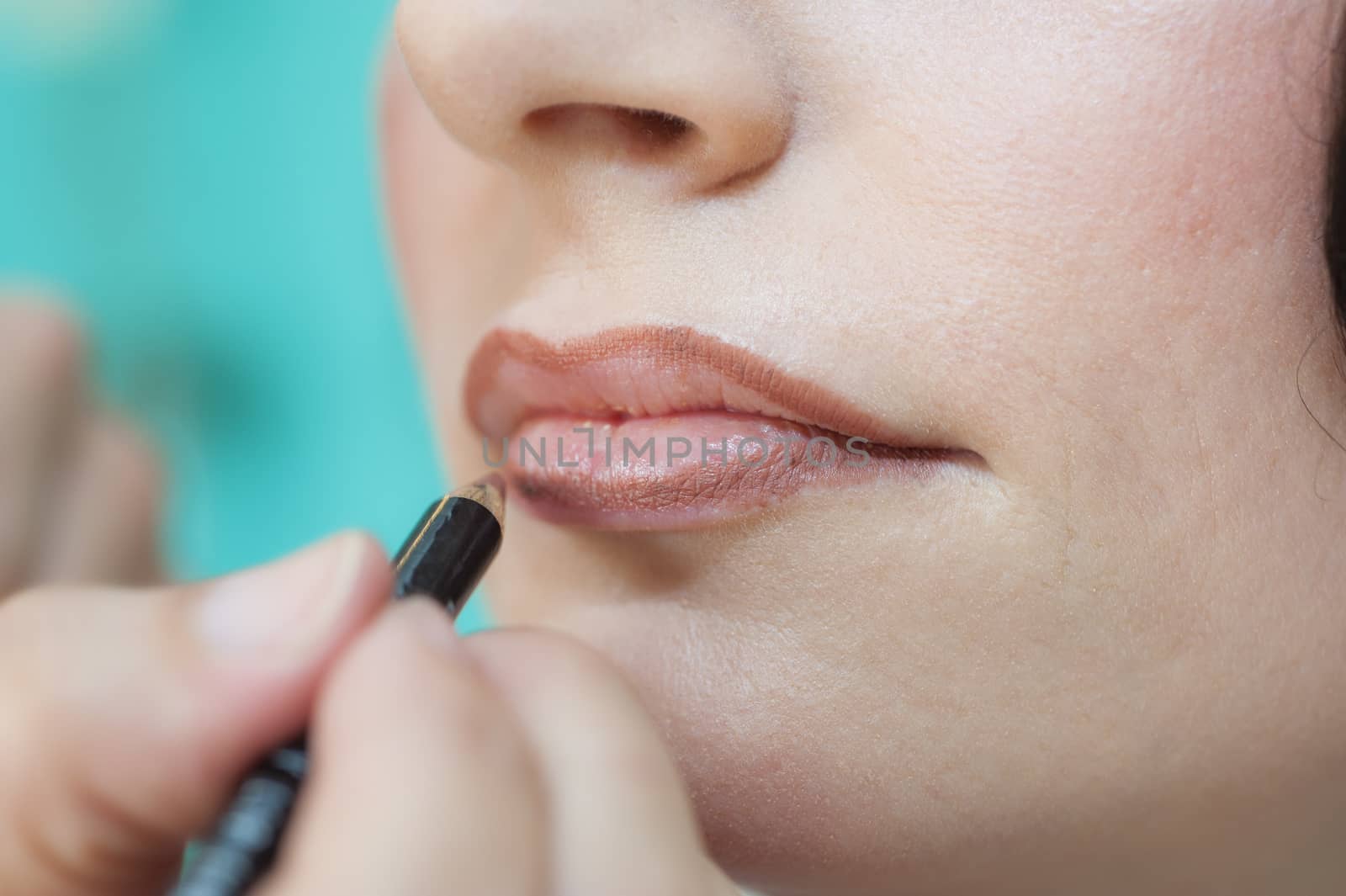 Closeup of woman applying lipstick by paulvinten